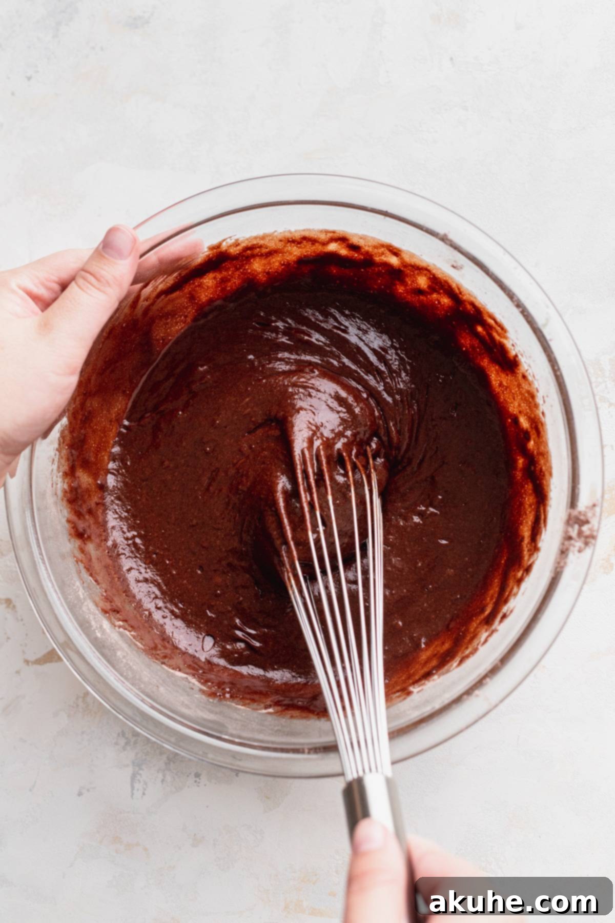 Decadent Black Forest Cupcakes 4 Rich chocolate cake batter resting in a clear glass bowl, smooth and ready for baking.