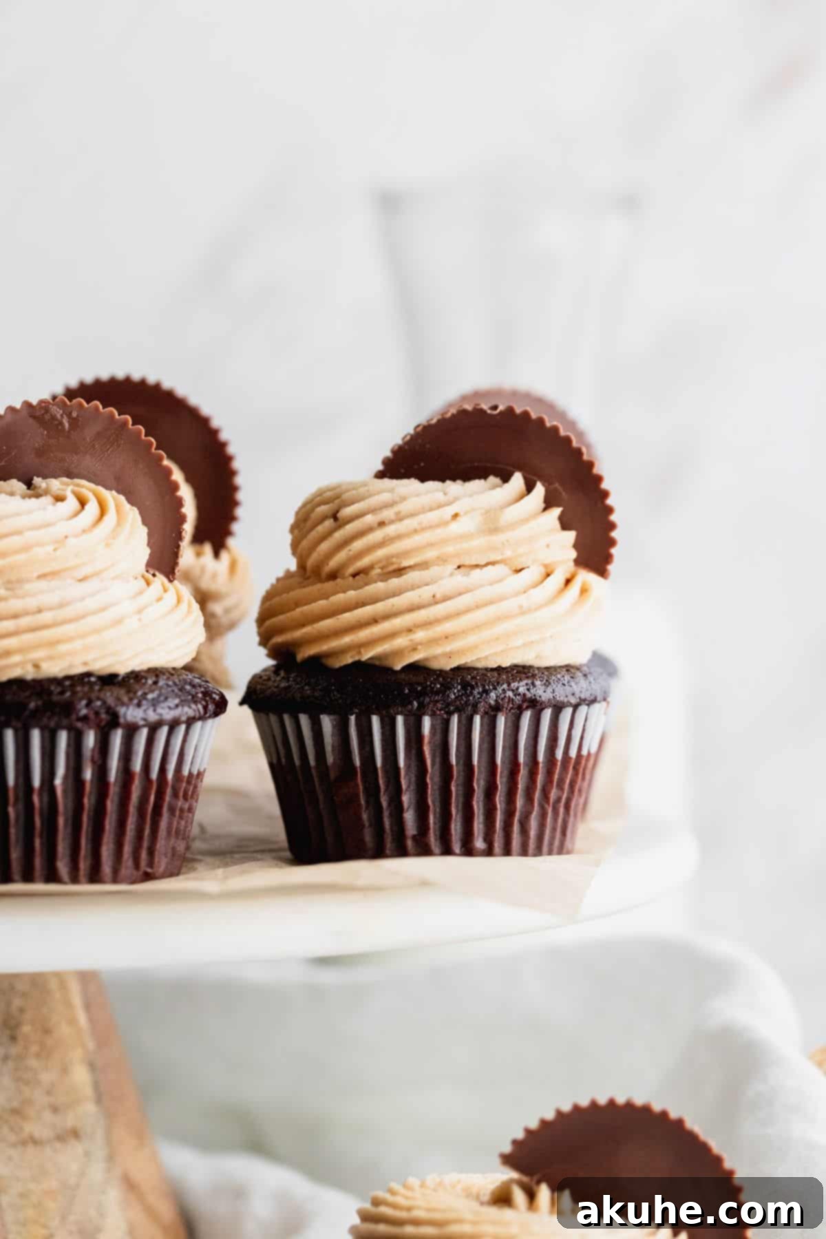 Peanut butter chocolate cupcakes on a cake stand.