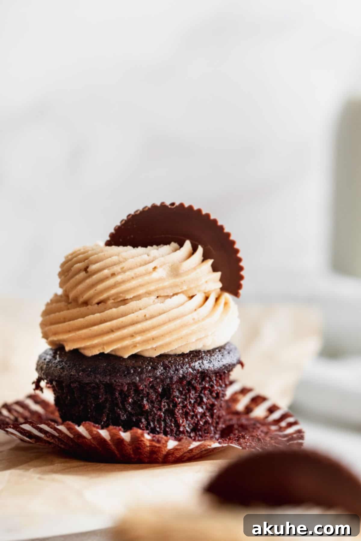 Wrapper taken off cupcake on platter.