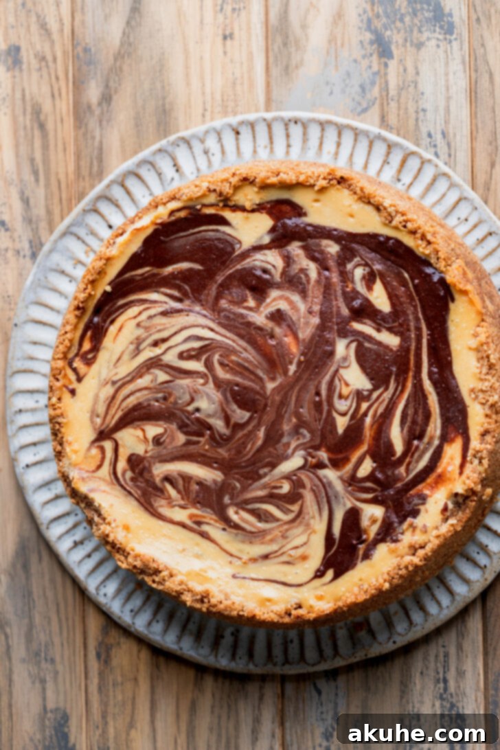 A perfectly baked and chilled cheesecake, removed from its pan and placed on a beautiful serving platter, ready for its luscious toppings.