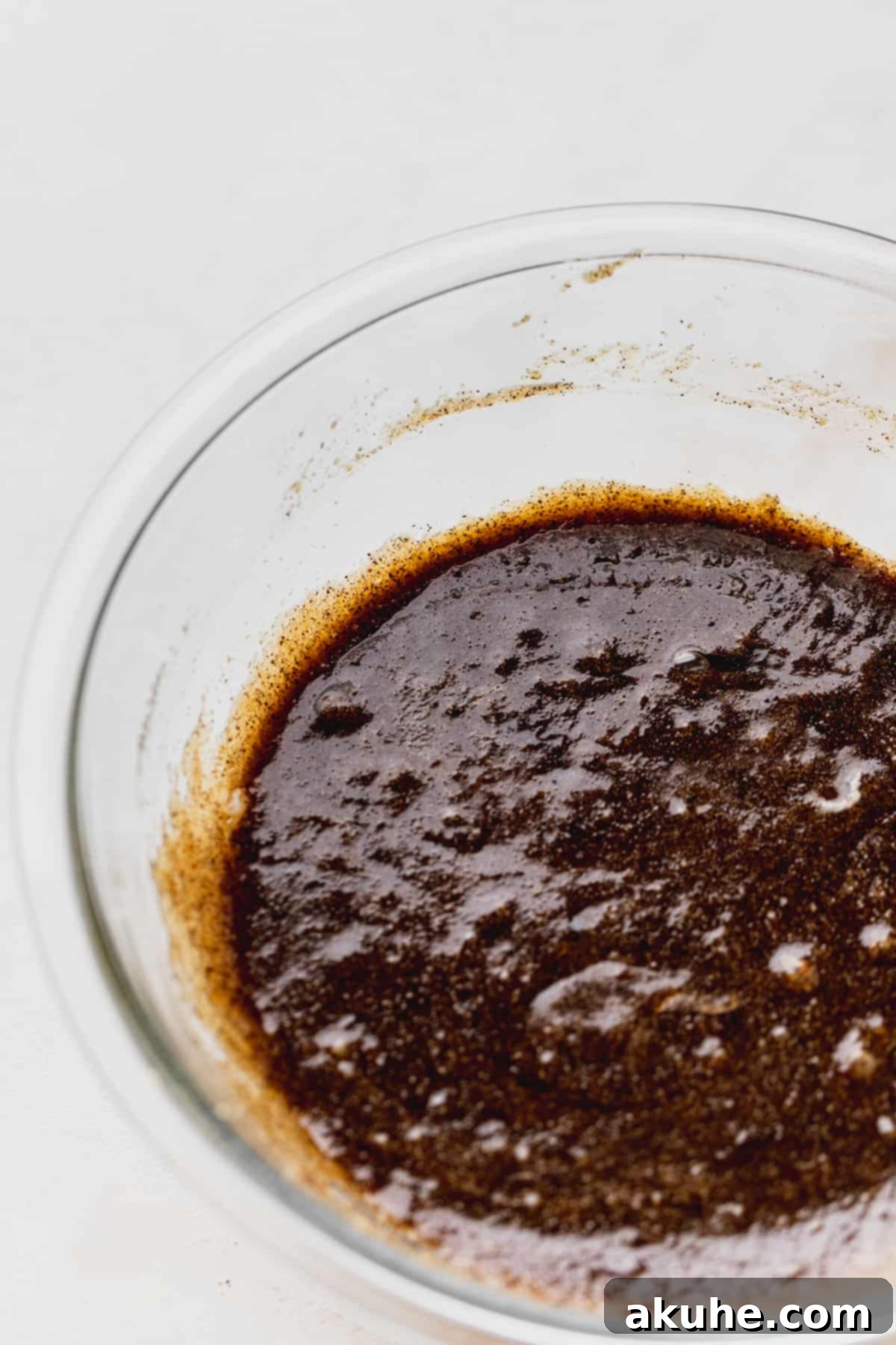 Cookie dough mixture in a glass mixing bowl, showcasing its rich color and texture.