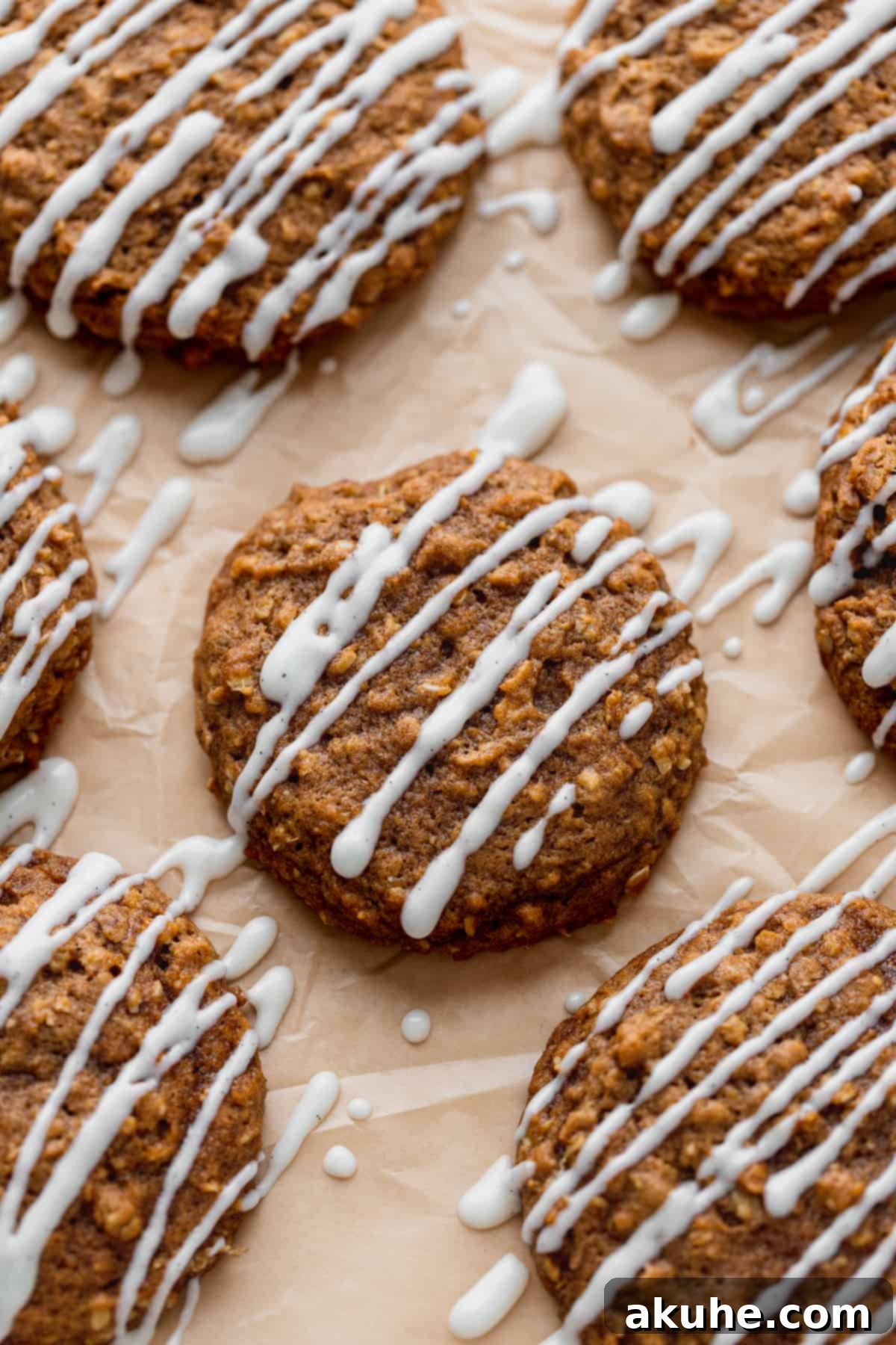 Pumpkin oatmeal cookies neatly arranged on parchment paper on a baking sheet, ready for serving.