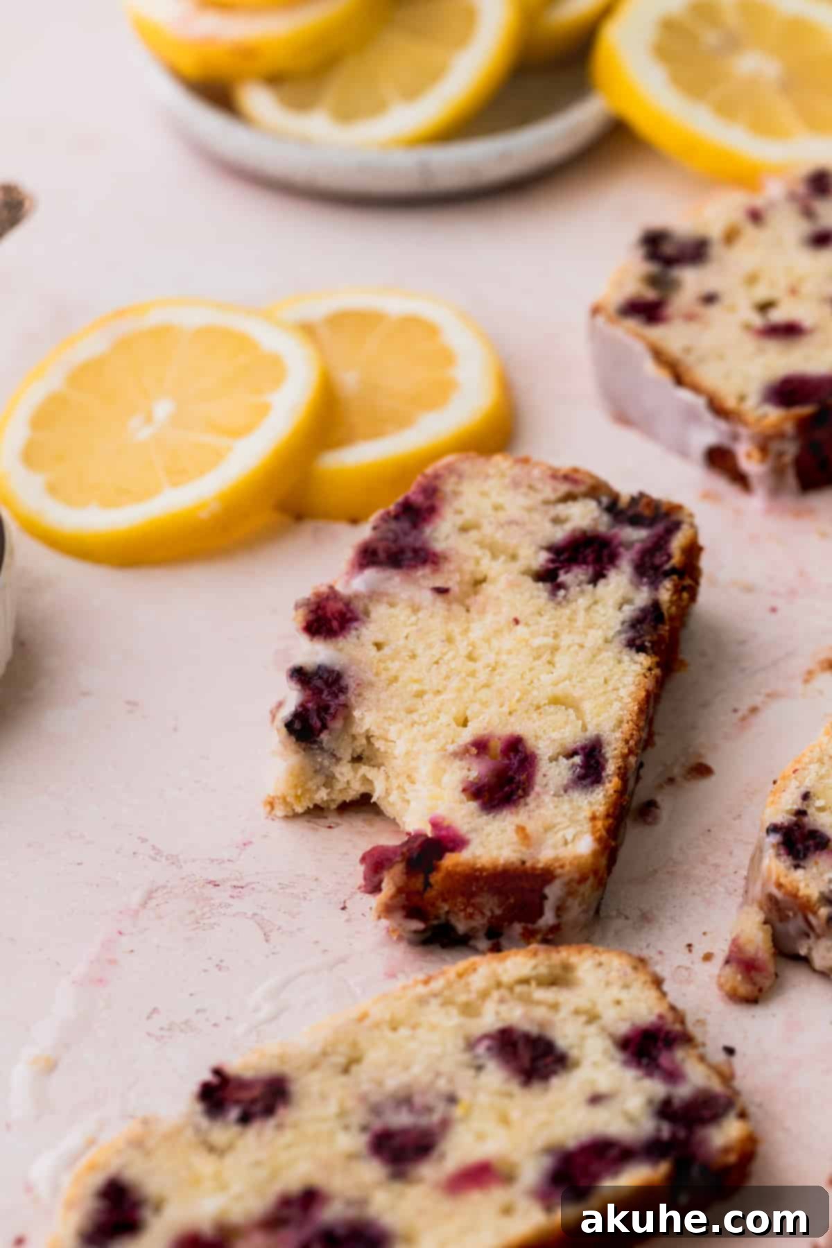 Zesty Blackberry Lemon Loaf 12 A bite missing from lemon bread.