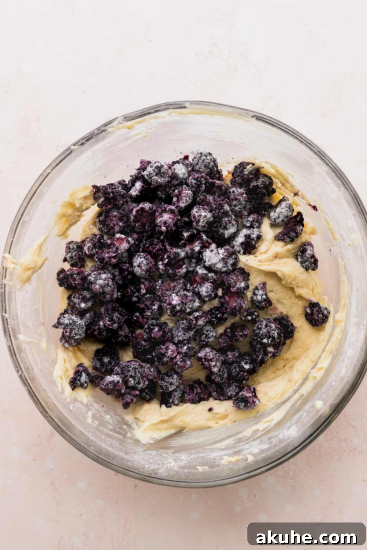 Zesty Blackberry Lemon Loaf 5 Lemon batter in a glass bowl with blackberries on top.