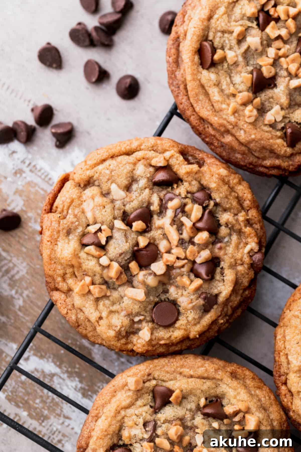 Golden brown brown butter toffee chocolate chip cookies cooling on a wire rack, ready to be enjoyed.