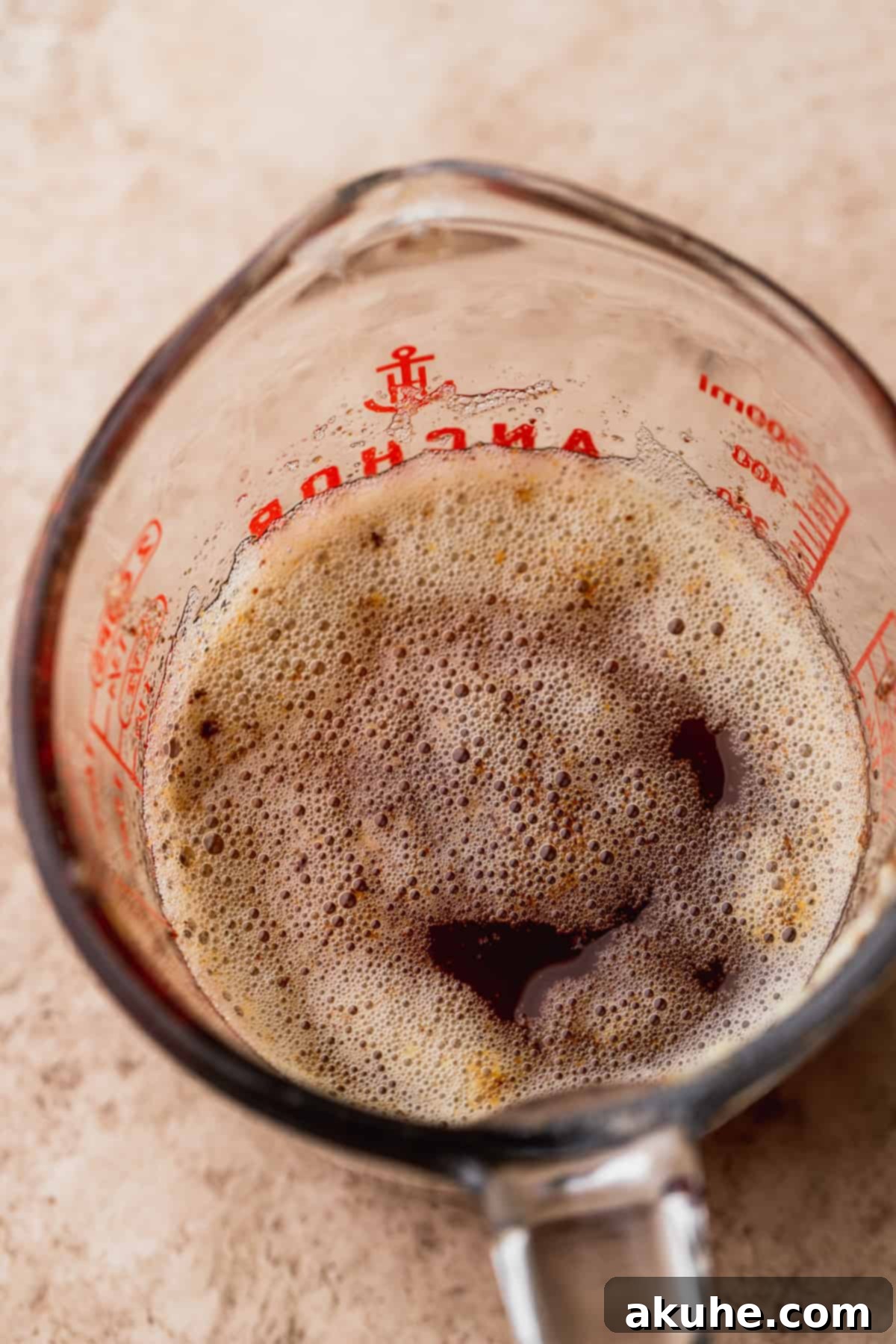 Rich, amber-colored brown butter in a glass bowl, showcasing its nutty essence.