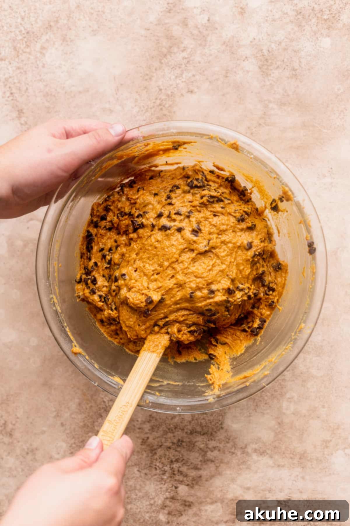 Mixing batter in a glass bowl.