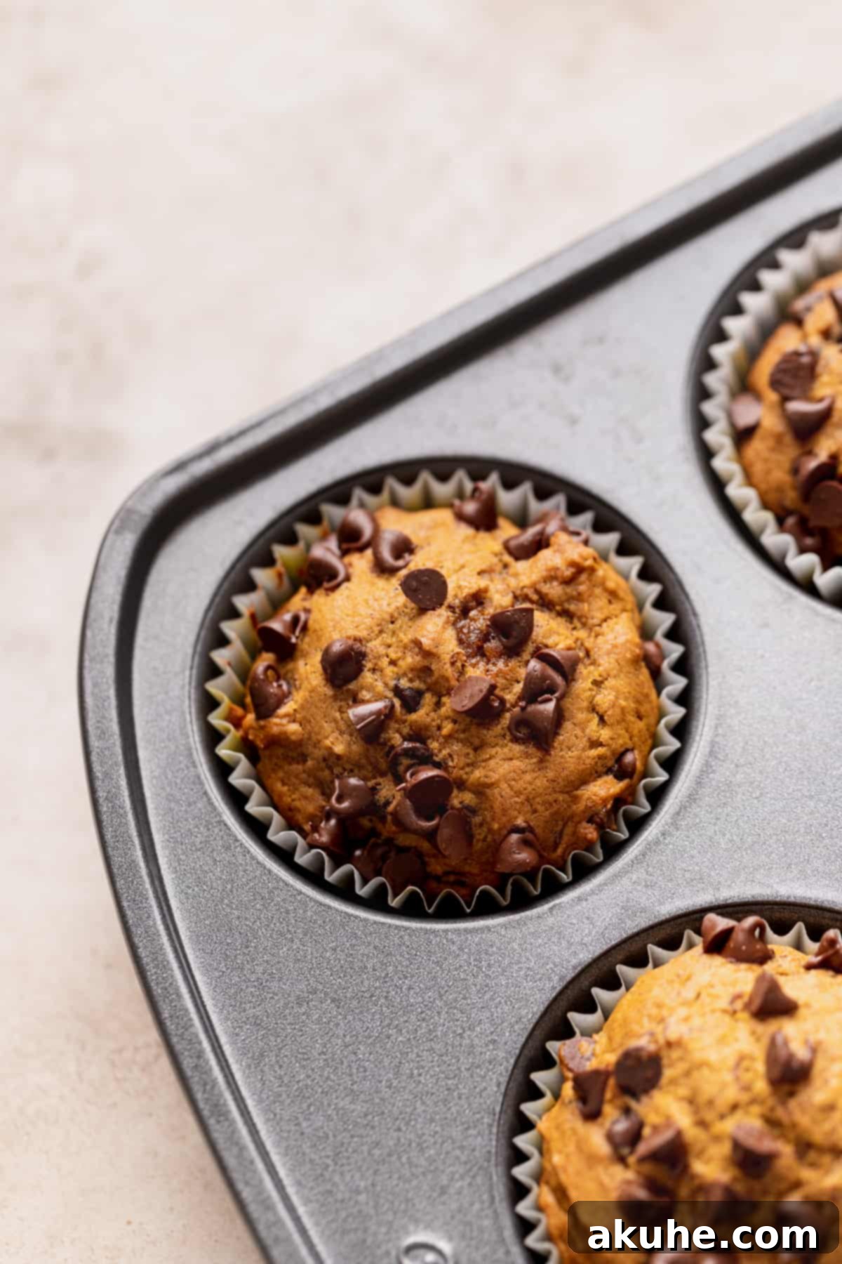 Freshly baked muffins cooling in their muffin pan.