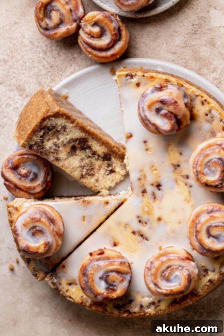Cinnamon Swirl Cheesecake 3 A single, delectable slice of Cinnamon Roll Cheesecake, highlighting the exquisite layers of cinnamon swirl, positioned next to the remaining whole cake.