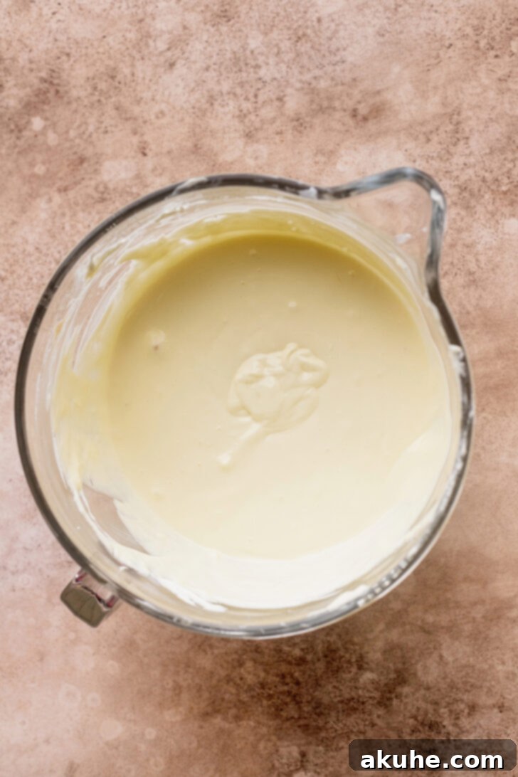 Cinnamon Swirl Cheesecake 4 Creamy cheesecake batter in a mixing bowl, ready for the next step.