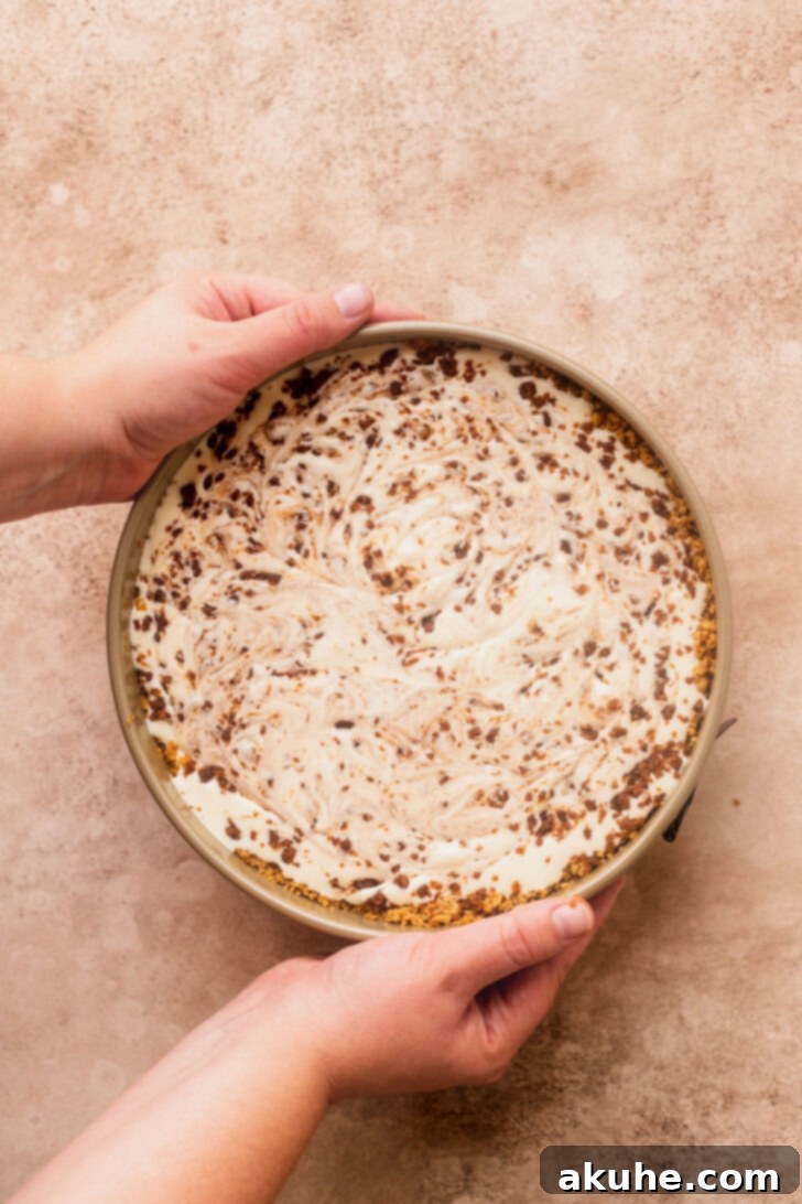 Cinnamon Swirl Cheesecake 7 Unbaked cheesecake batter with a cinnamon swirl pattern on top, created with a toothpick.