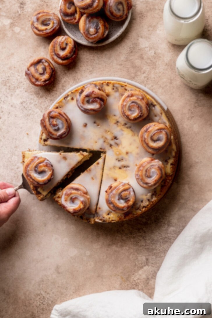 Cinnamon Swirl Cheesecake 9 Aerial view of the complete Cinnamon Roll Cheesecake, showcasing its glossy vanilla glaze and inviting cinnamon swirls.