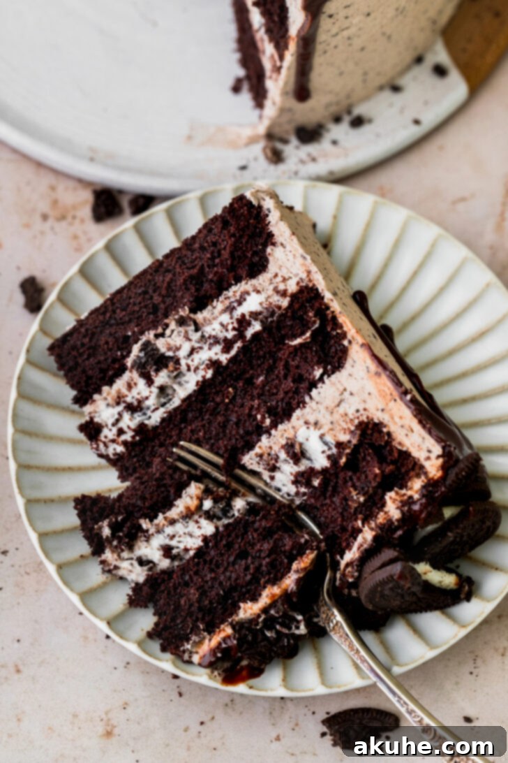 Decadent Oreo Dream Cake 3 Close-up of a delightful slice of Oreo cake on a white plate
