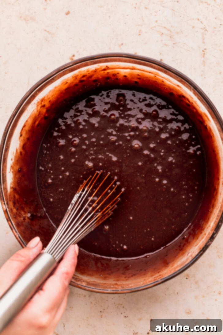 Decadent Oreo Dream Cake 4 Smooth chocolate cake batter in a mixing bowl, ready for baking
