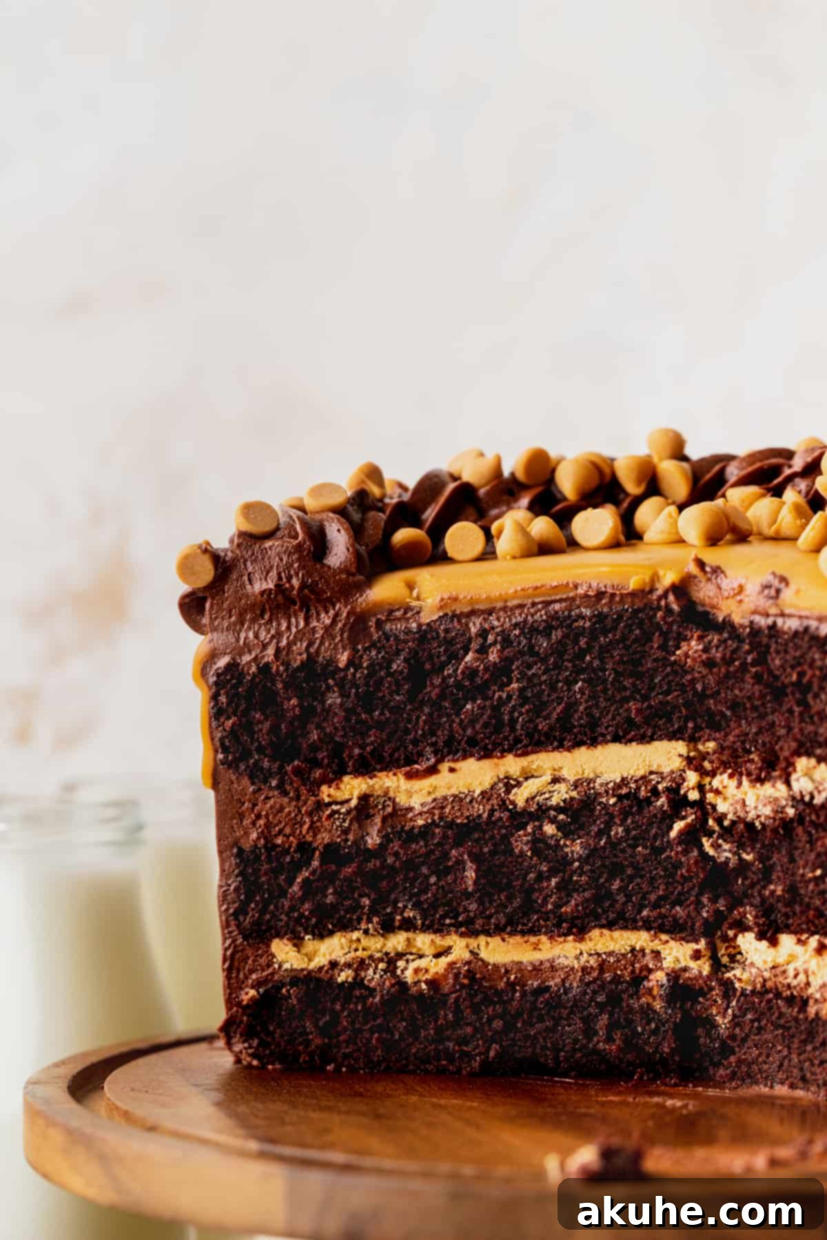 A perfectly cut Chocolate Butterscotch Cake, revealing its beautiful layers of chocolate cake, whipped butterscotch ganache, and frosting.