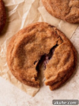 Churro Cookie Delights 11 One churro cookie split in half, showcasing the melted chocolate filling.