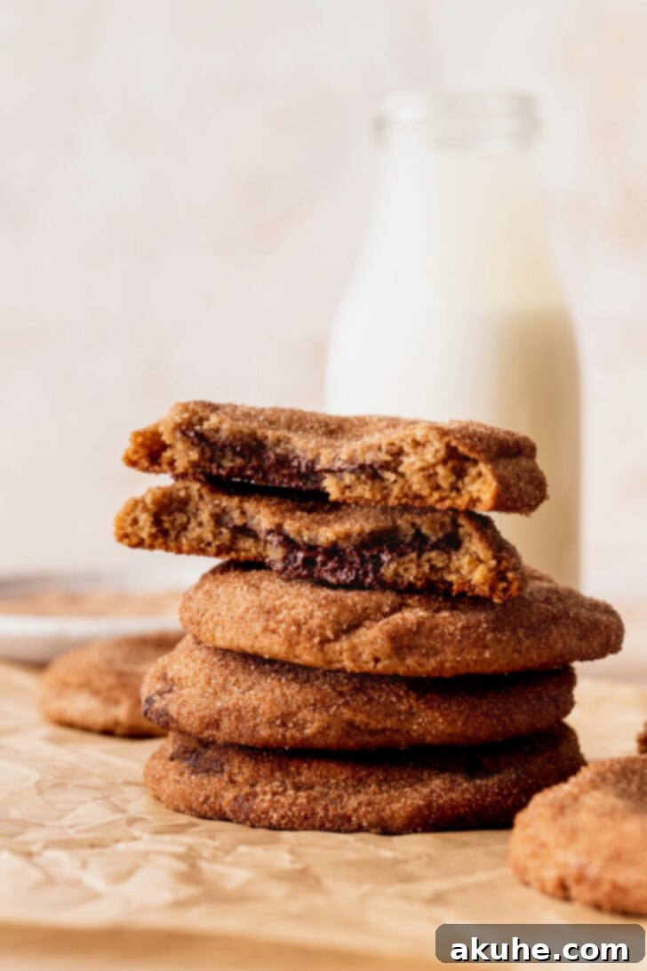 Churro Cookie Delights 10 A stack of three churro cookies, showing their thick, inviting texture and generous cinnamon-sugar coating.