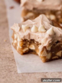 Bite missing from white chocolate cinnamon blondies.