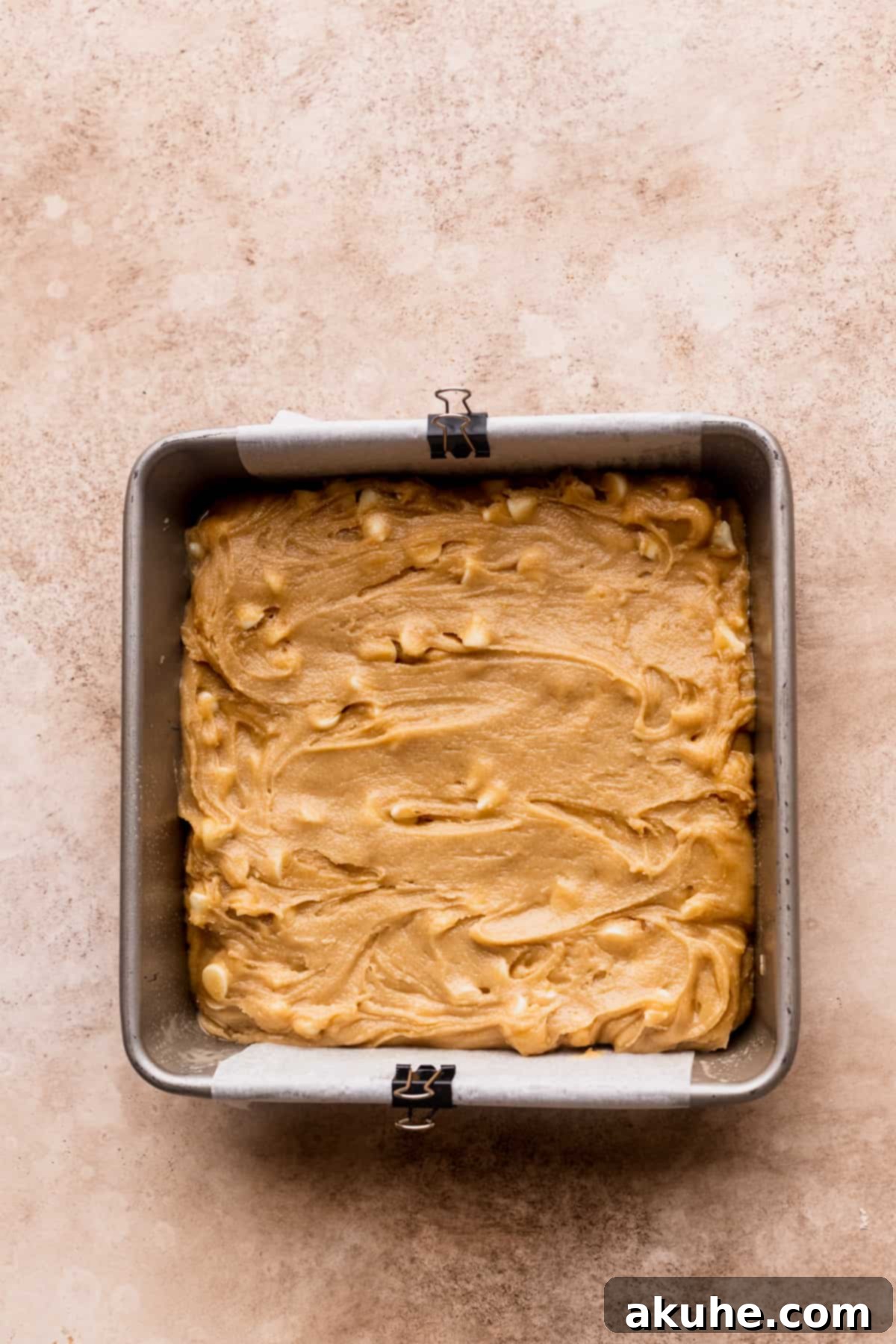 Blondie batter smoothly spread in a prepared baking pan.