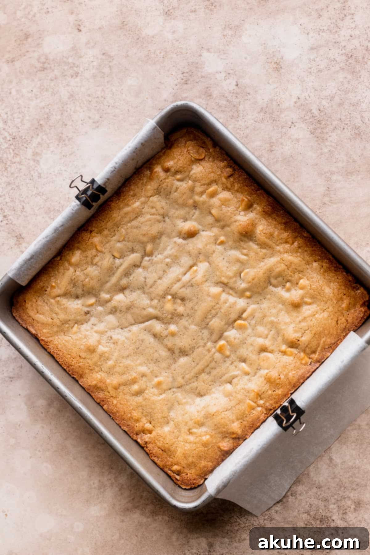 Freshly baked blondies cooling in the pan after coming out of the oven.