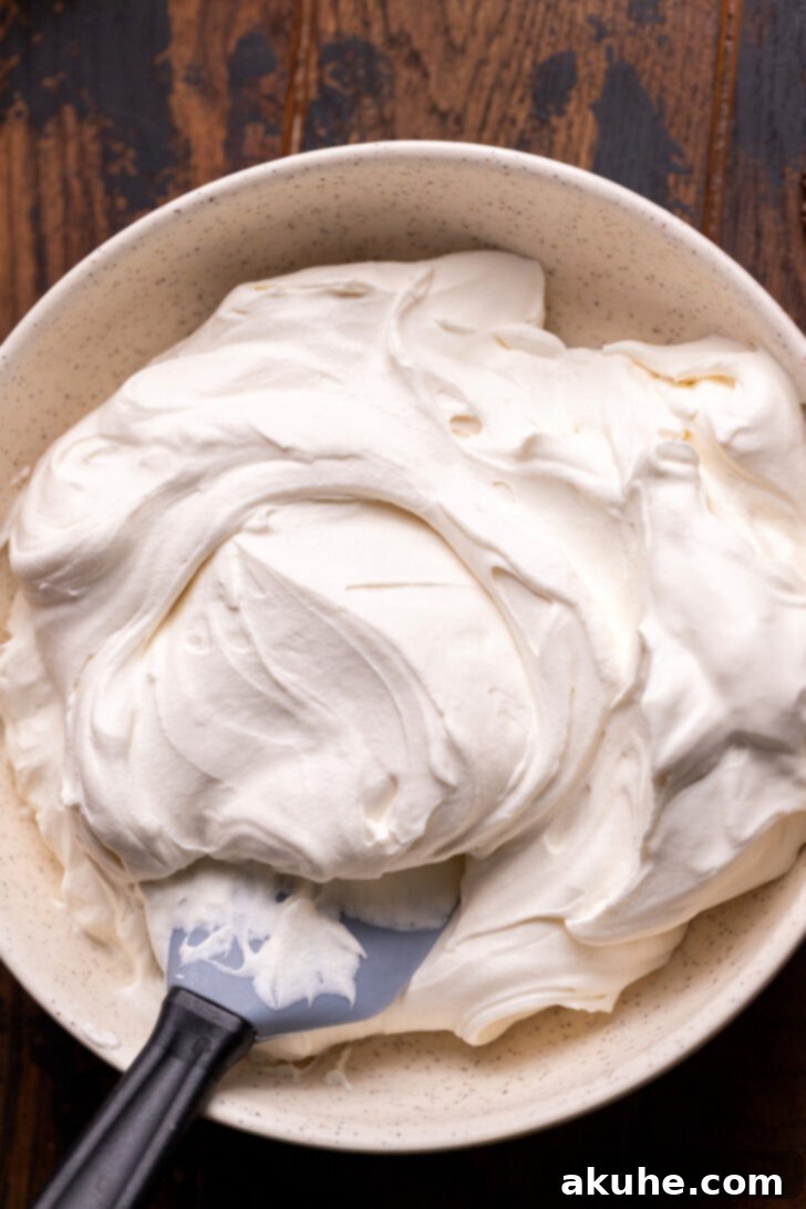 Mascarpone Mocha Cheesecake 8 Fluffy whipped mascarpone cream in a mixing bowl, ready for topping the cheesecake.