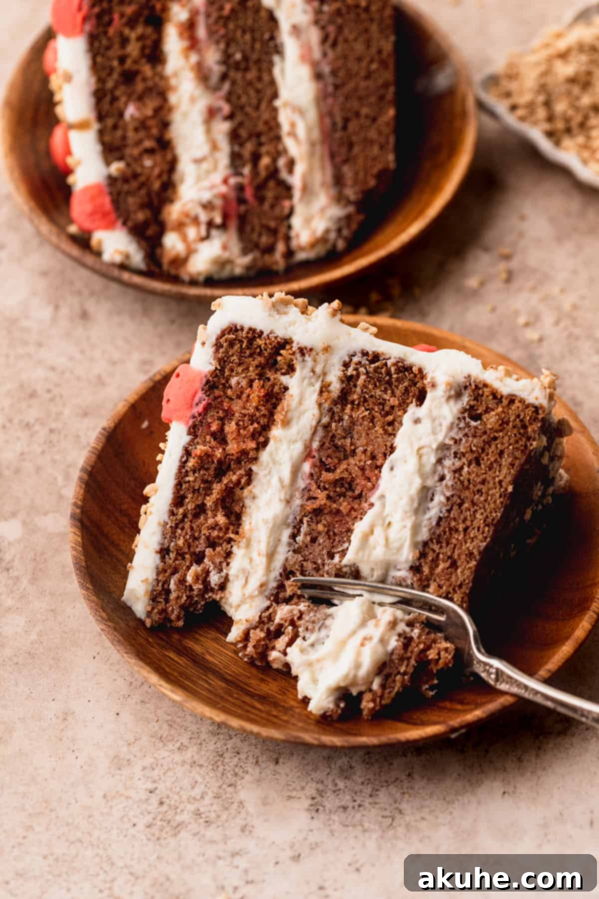 Irresistible Apple Toffee Cake 12 A fork taking a bite out of a delicious slice of Apple Toffee Layered Cake.