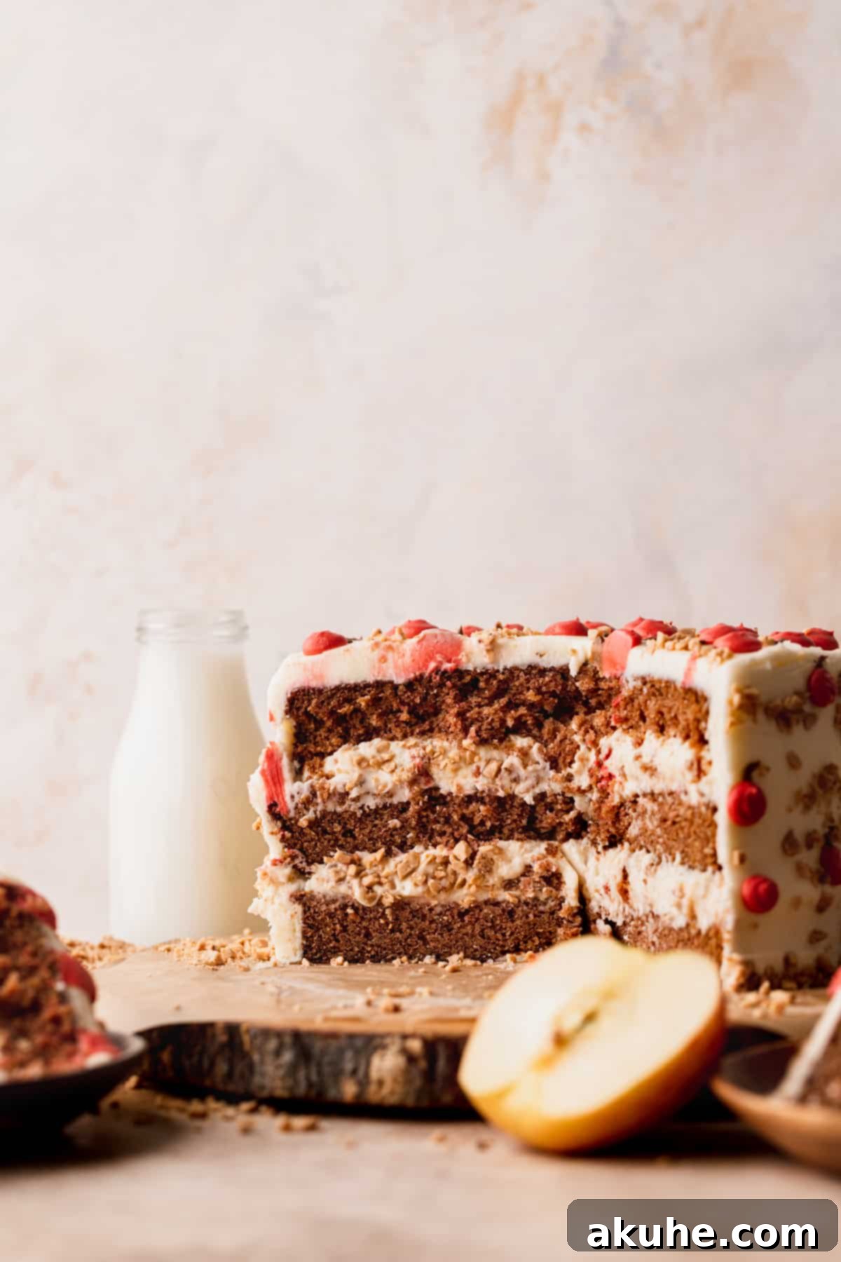 Irresistible Apple Toffee Cake 5 An Apple Toffee Layered Cake cut in half, showcasing its multiple layers of cake, filling, and frosting.