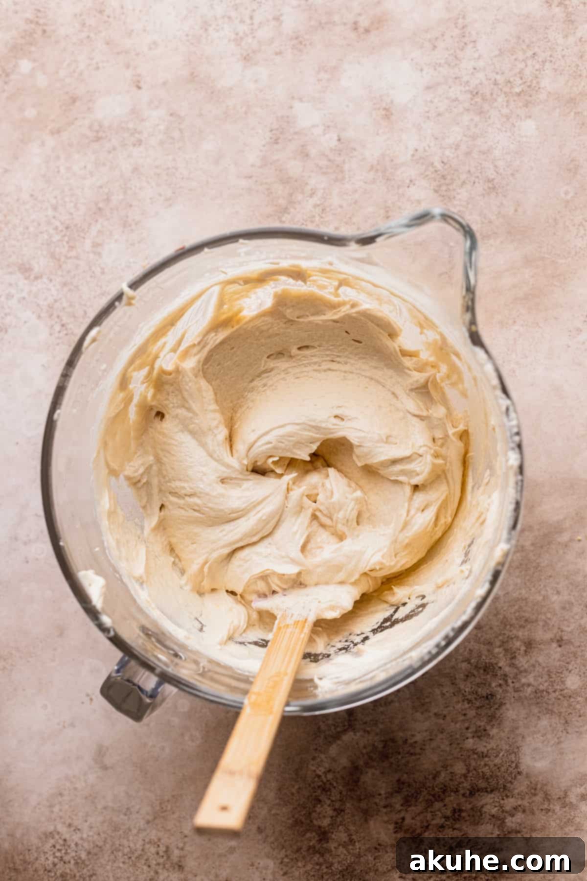 Irresistible Apple Toffee Cake 7 Smooth, light-colored wet cake batter in a clear glass bowl, showcasing its fluffy texture.