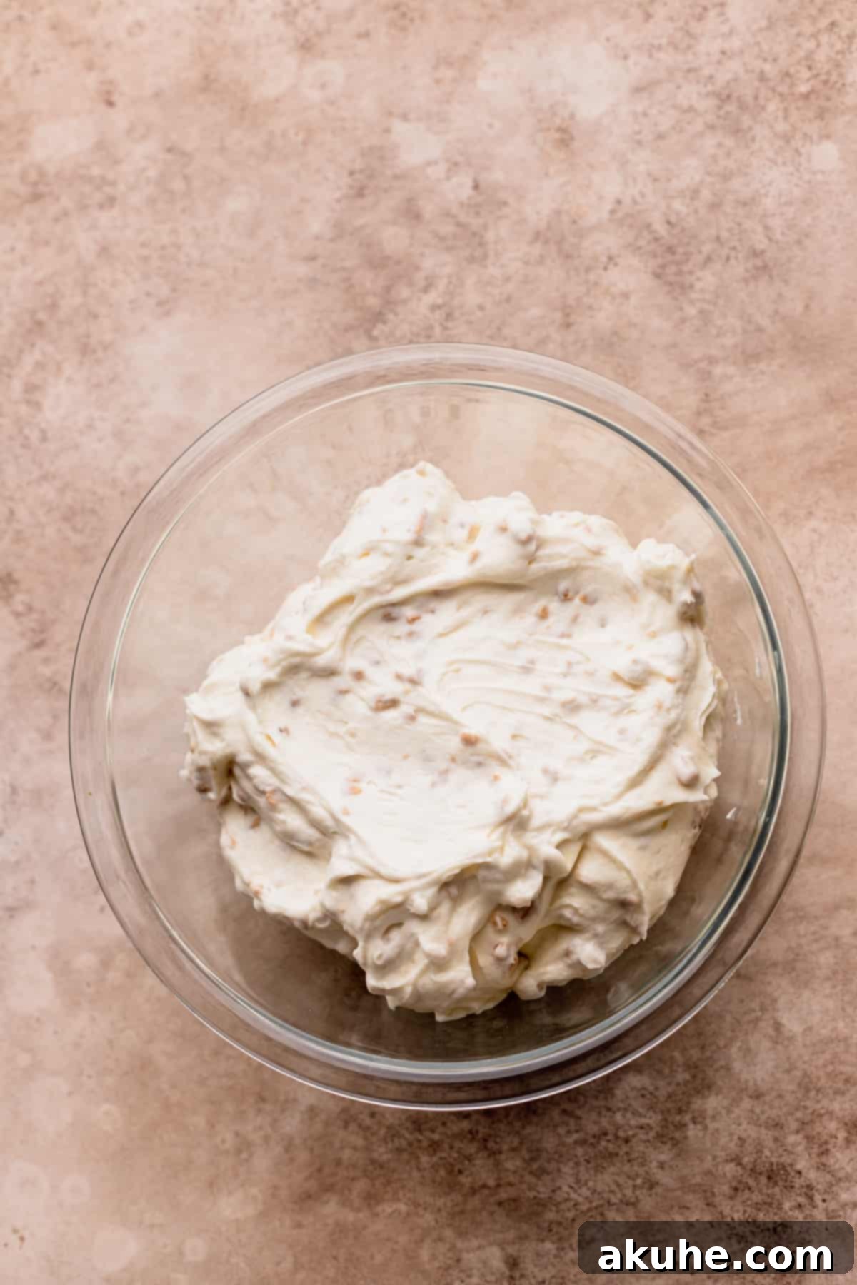 Irresistible Apple Toffee Cake 9 A bowl of creamy Toffee Whipped Cream Cheese filling, ready to be spread.