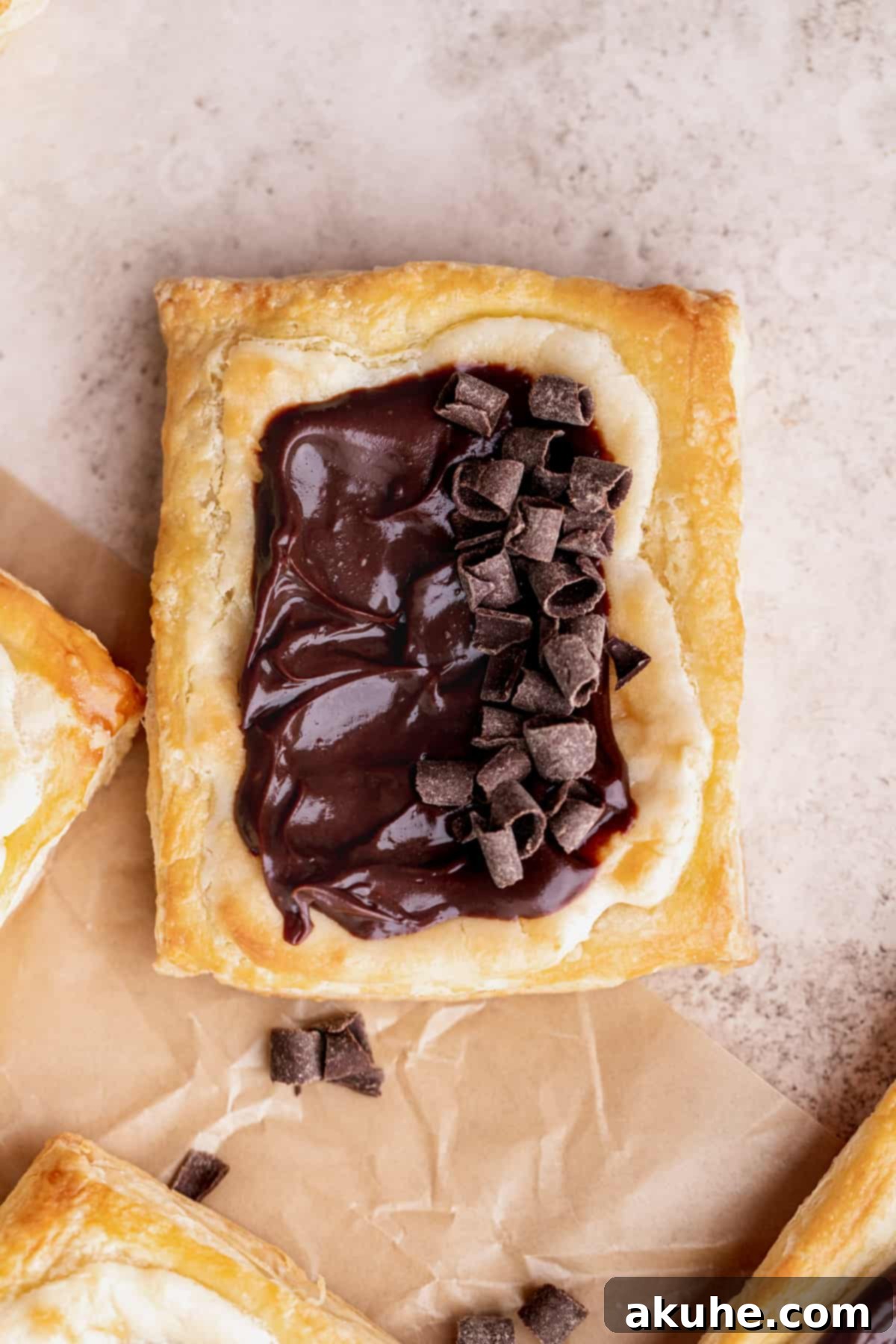 Indulgent Chocolate Cream Cheese Danish 3 Pastry with chocolate curls on top.