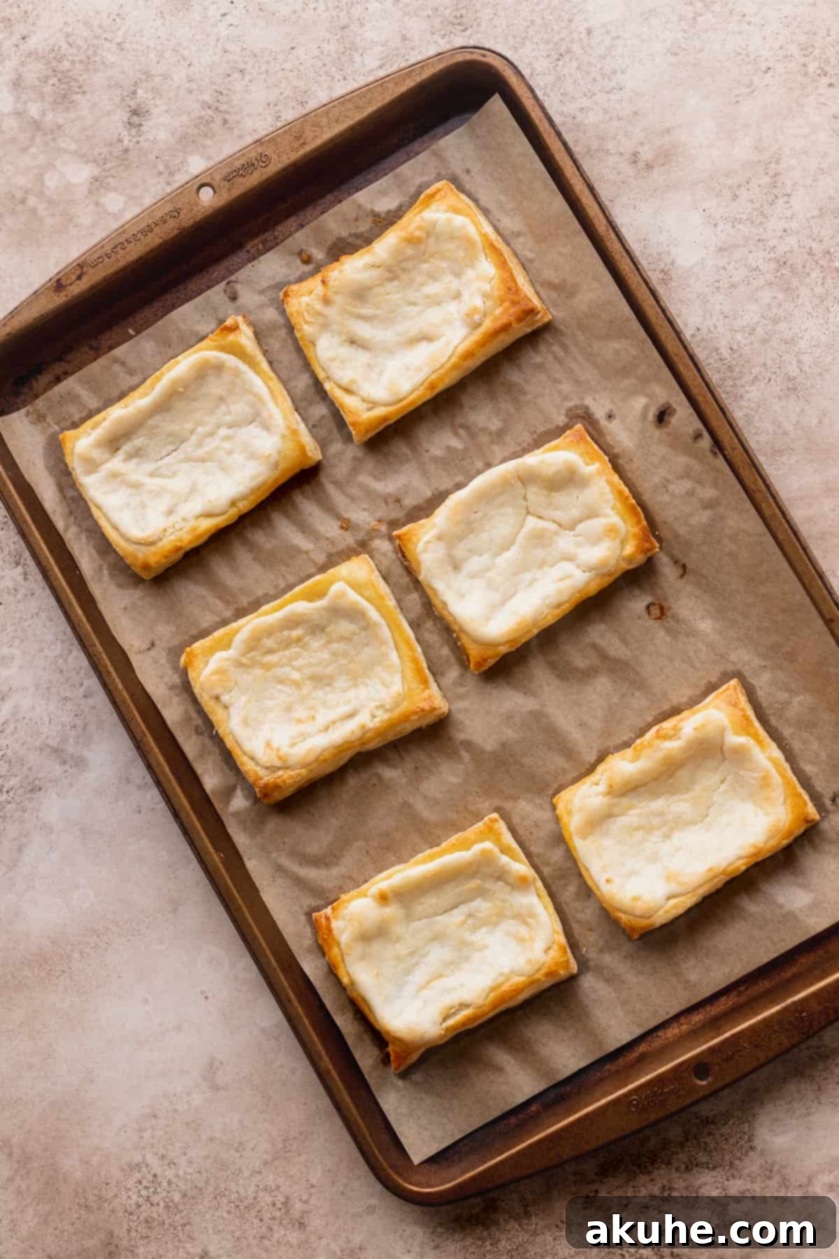 Indulgent Chocolate Cream Cheese Danish 7 Baked pastry on top of cookie sheet.