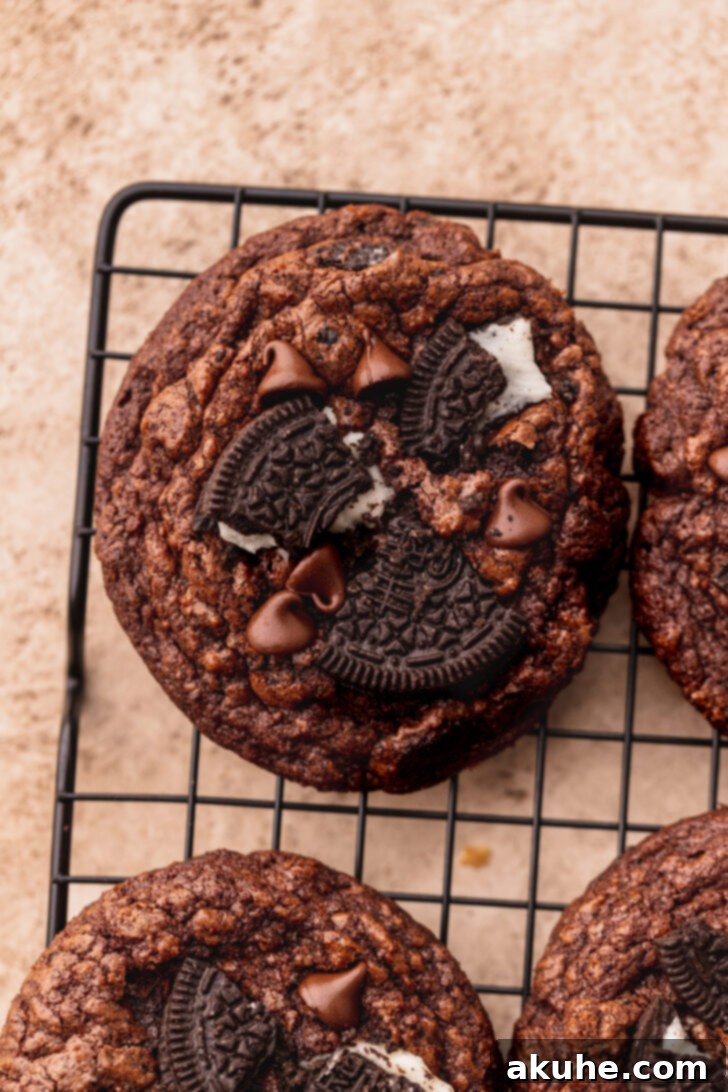 Decadent Oreo Brownie Cookies 2 A top-down view of freshly baked Oreo brownie cookies arranged on a cooling rack, showcasing their rich chocolate color and visible Oreo pieces.