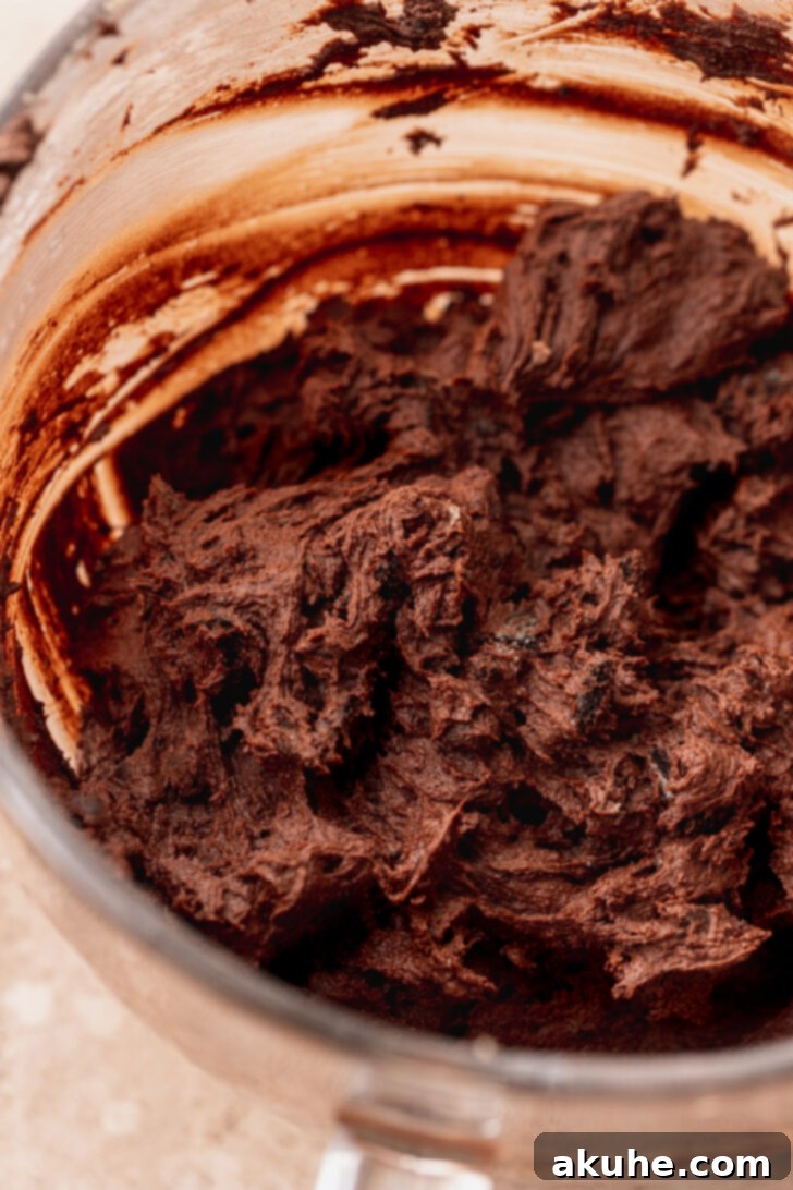 Decadent Oreo Brownie Cookies 6 Rich, dark chocolate cookie dough resting in a mixing bowl, ready for a brief chill before baking.
