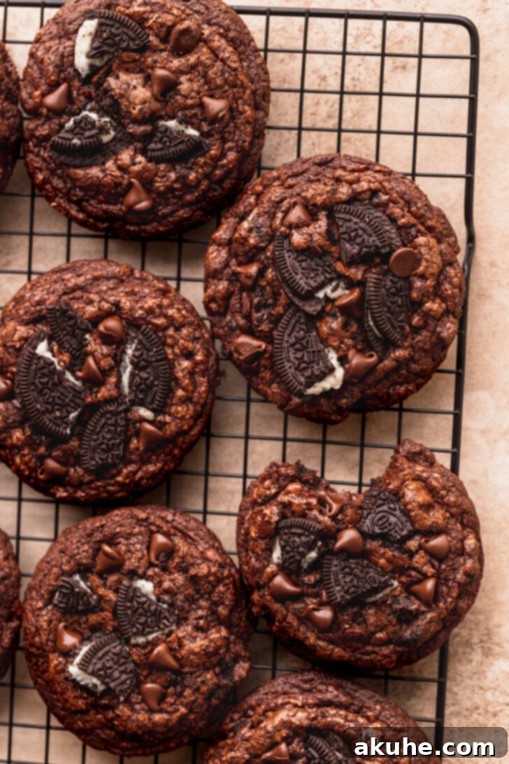 Decadent Oreo Brownie Cookies 9 An overhead shot of baked Oreo brownie cookies cooling on a wire rack, showcasing their uniform shape and appealing crinkle tops.
