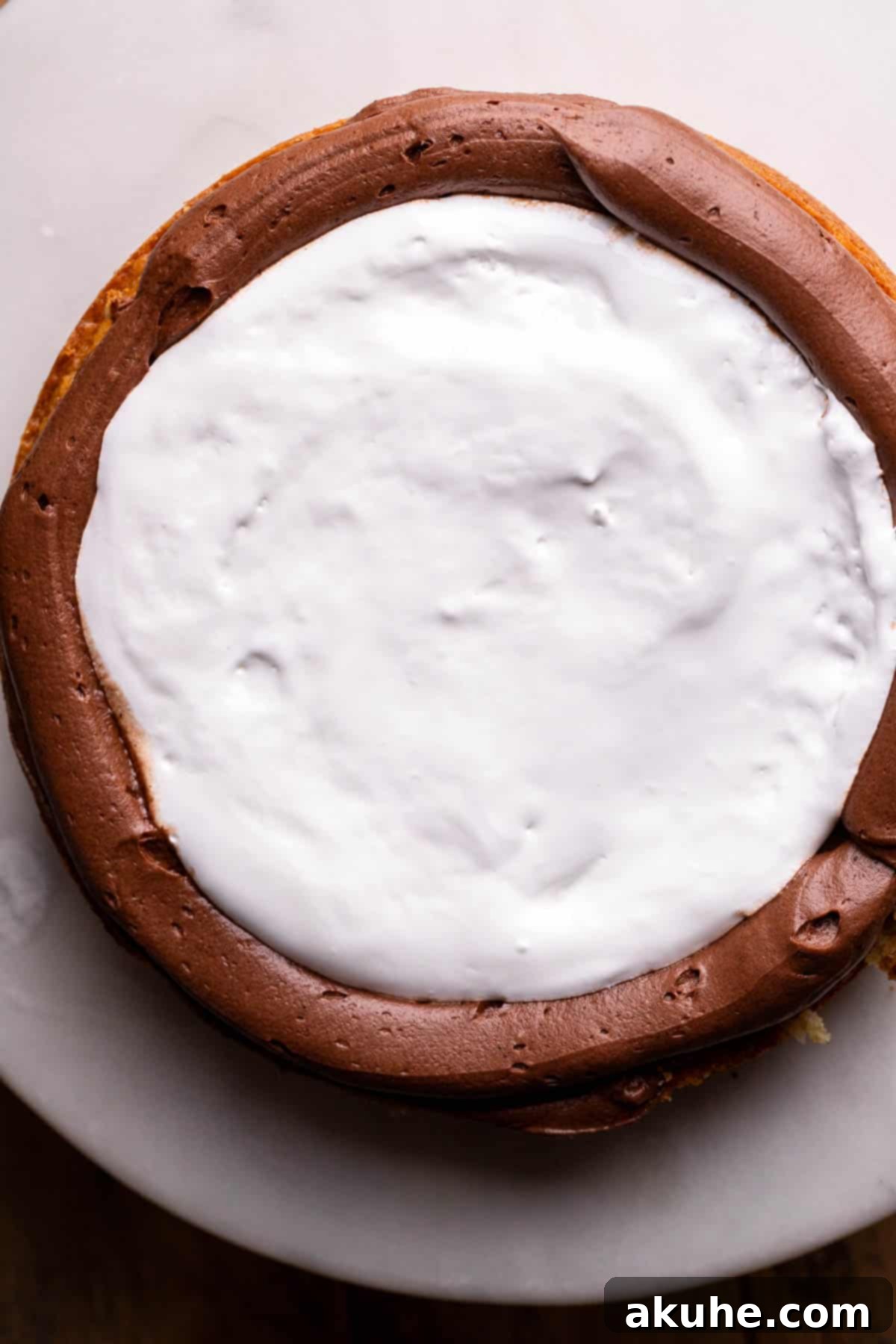 Ultimate Smores Cake 10 Marshmallow fluff spread on the cake layer.