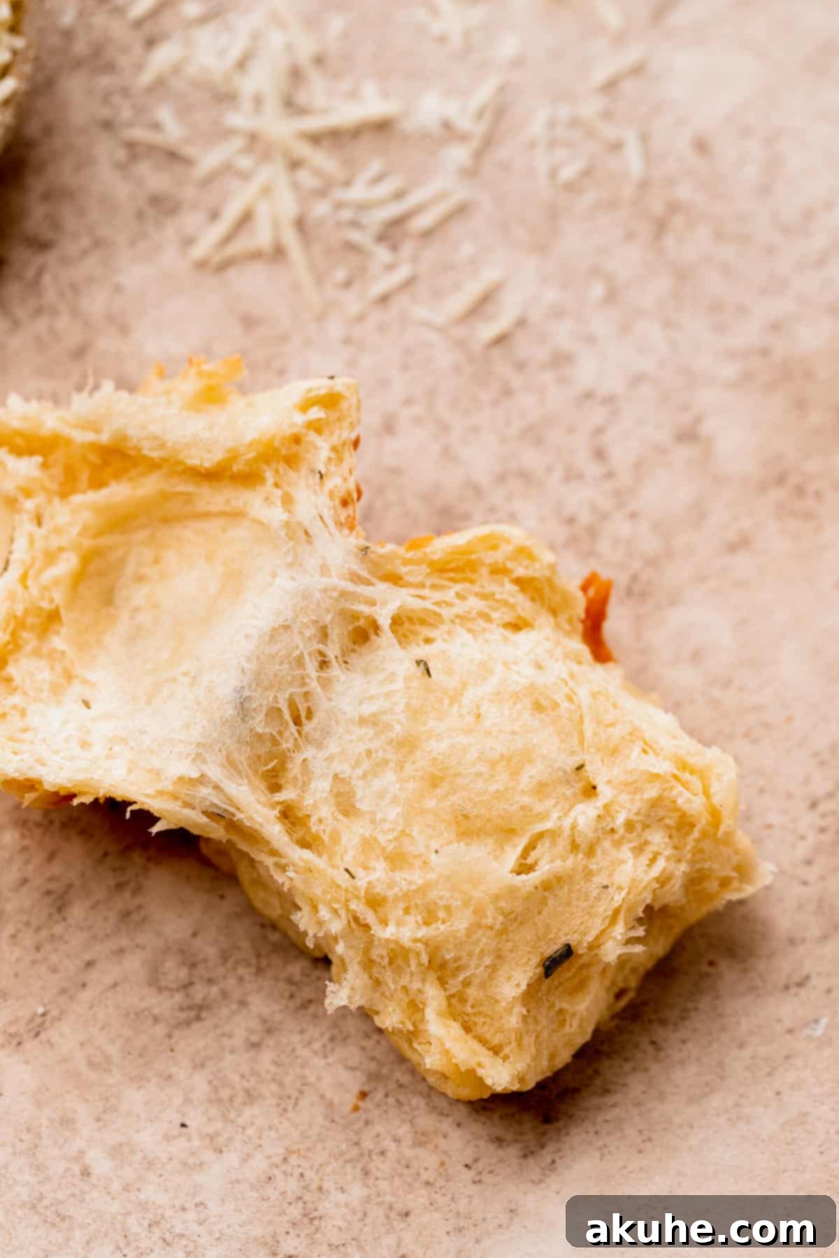 Fluffy cheddar cheese rolls split in half.