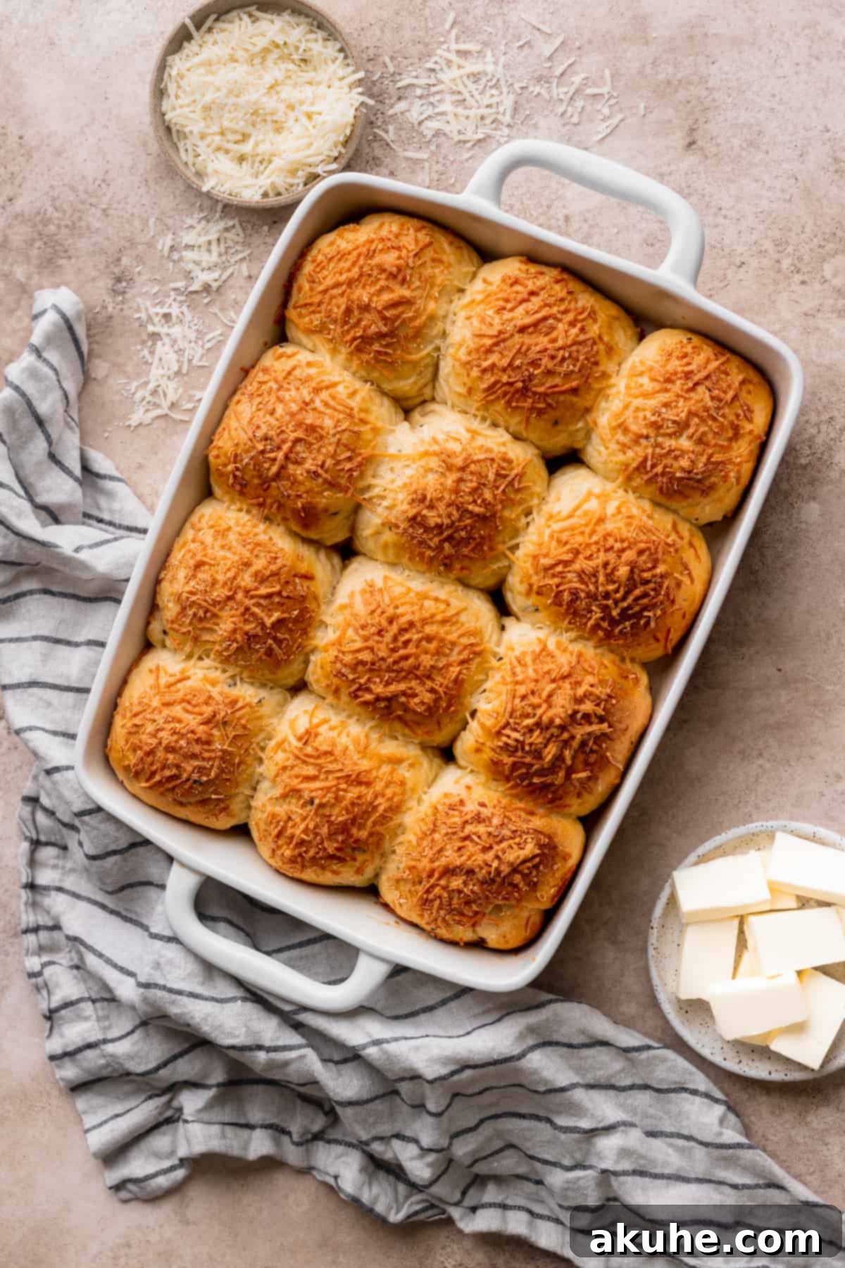 Baked fluffy cheddar cheese rolls in a pan.