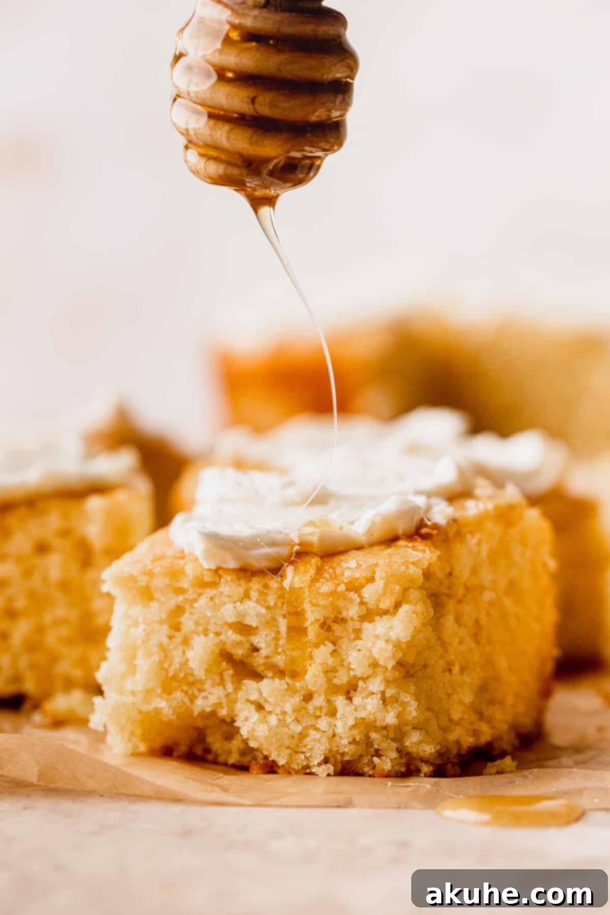 Buttery Honey Cornbread 3 Drizzling honey on top of cornbread.