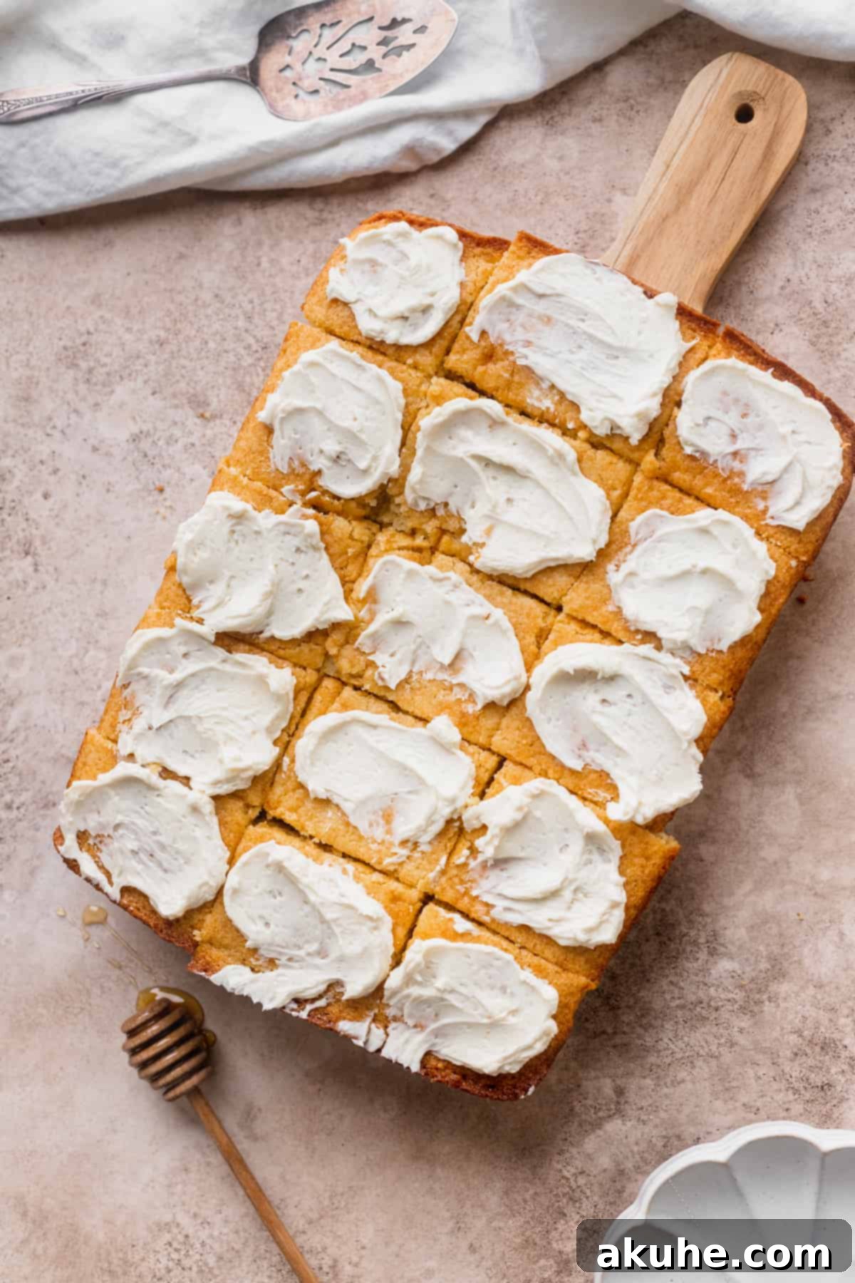 Buttery Honey Cornbread 9 Cornbread with butter on top of cutting board.