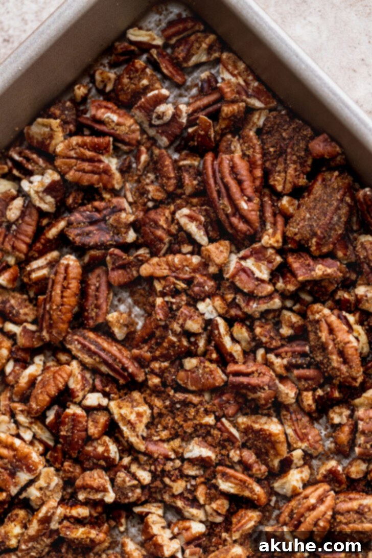 Toasted Pecan Chocolate Chip Delights 4 Finely chopped pecans spread out on a baking sheet, ready for roasting.