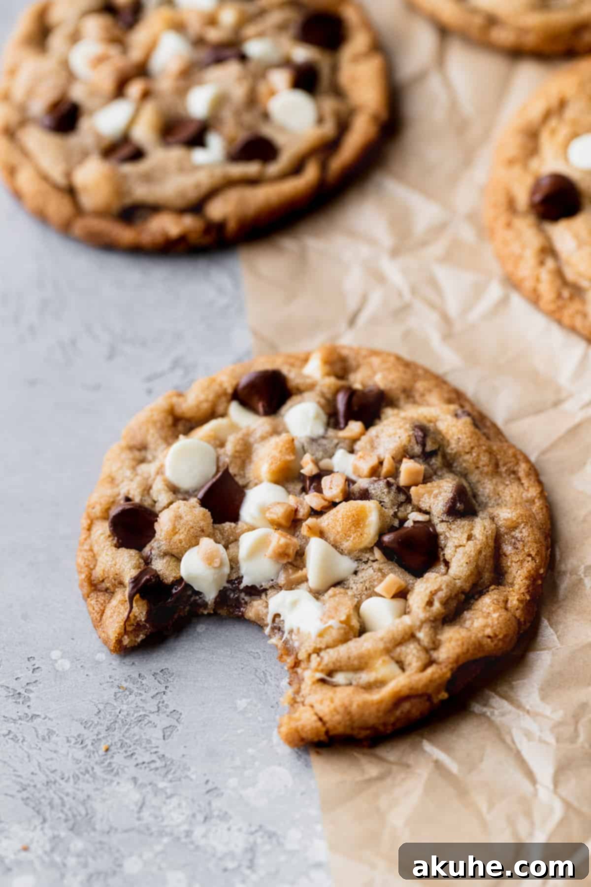 Decadent White Chocolate Toffee Cookies 2 A perfectly baked white chocolate toffee cookie with a bite missing, showcasing its chewy interior and abundant mix-ins.