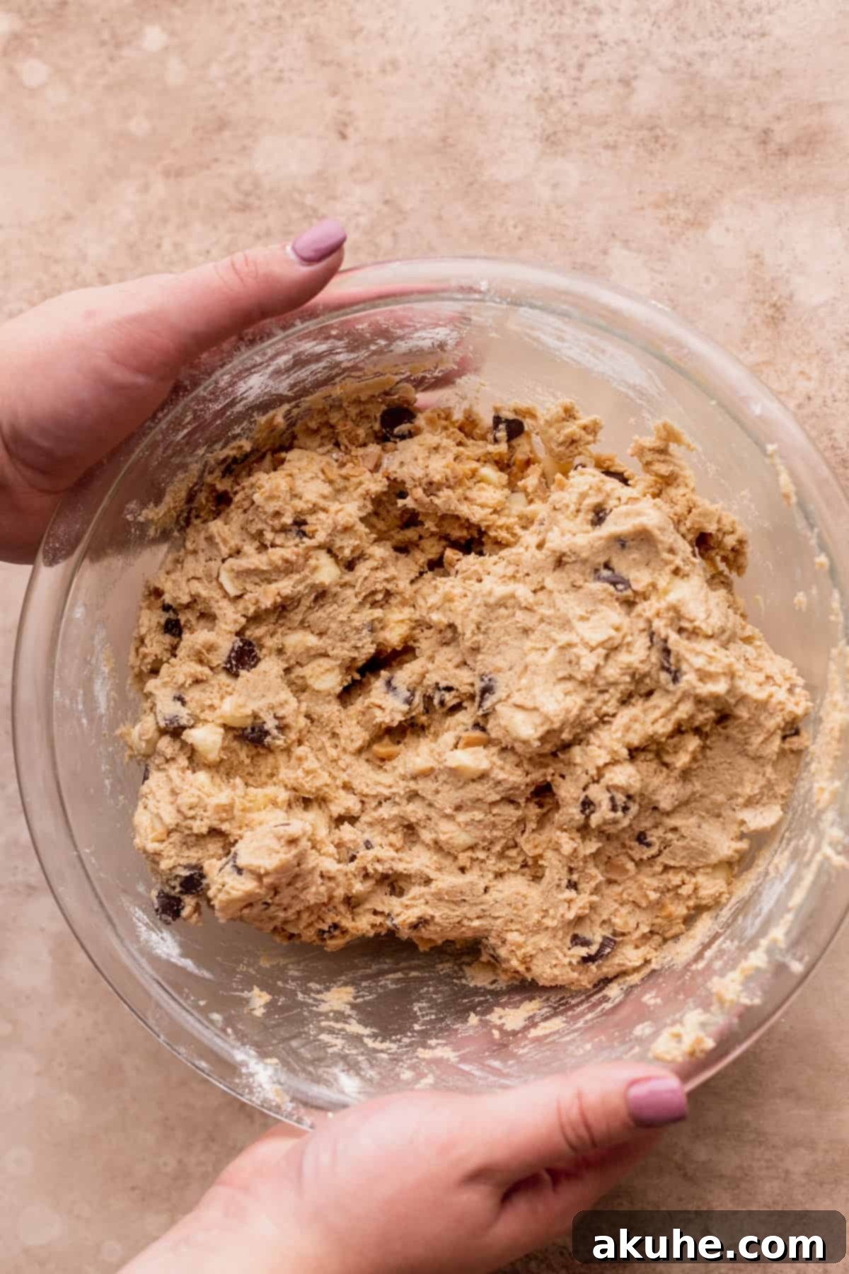 Decadent White Chocolate Toffee Cookies 9 Finished cookie dough with all mix-ins, resting in a glass bowl.