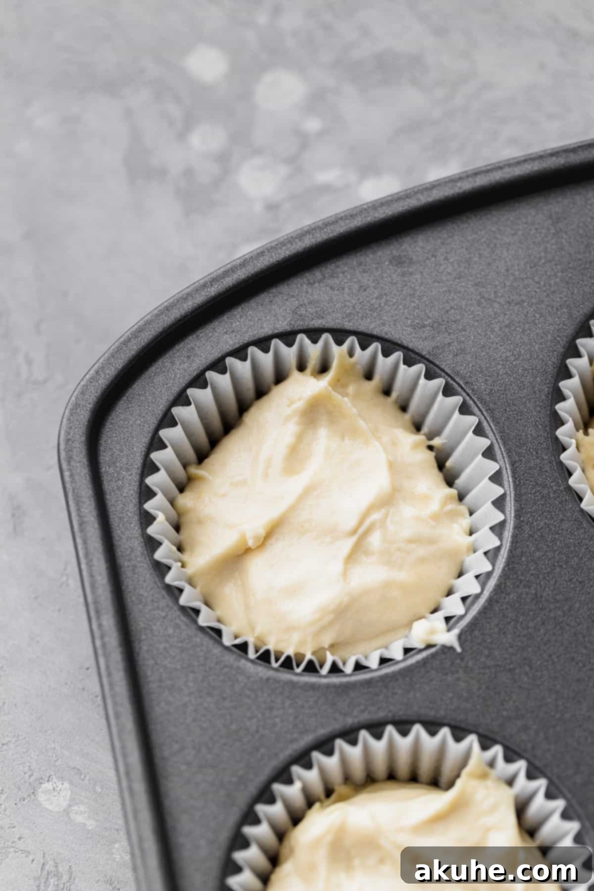 Decadent White Chocolate Cupcakes 7 Cupcake batter neatly filled into a muffin pan with cupcake liners.