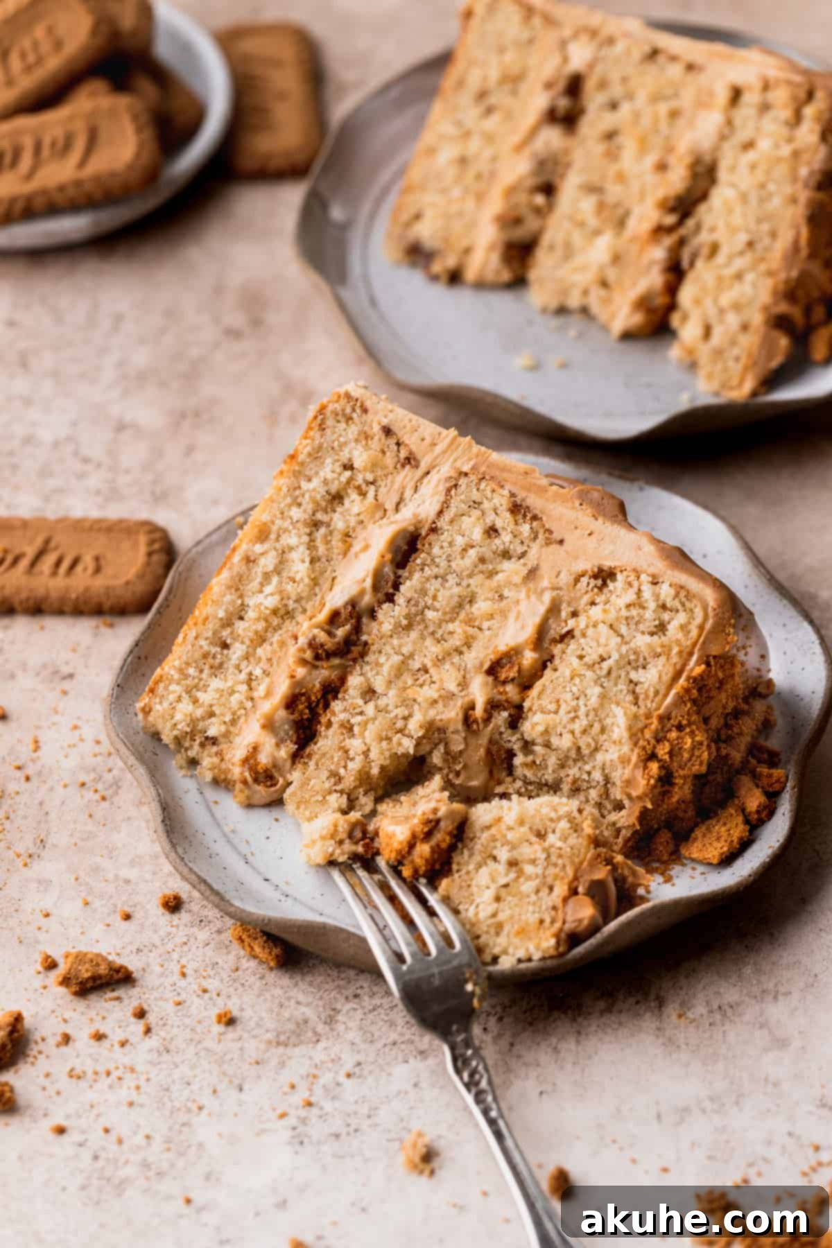 A stunning Biscoff layered cake presented on an elegant plate, highlighting its smooth frosting and inviting slices.