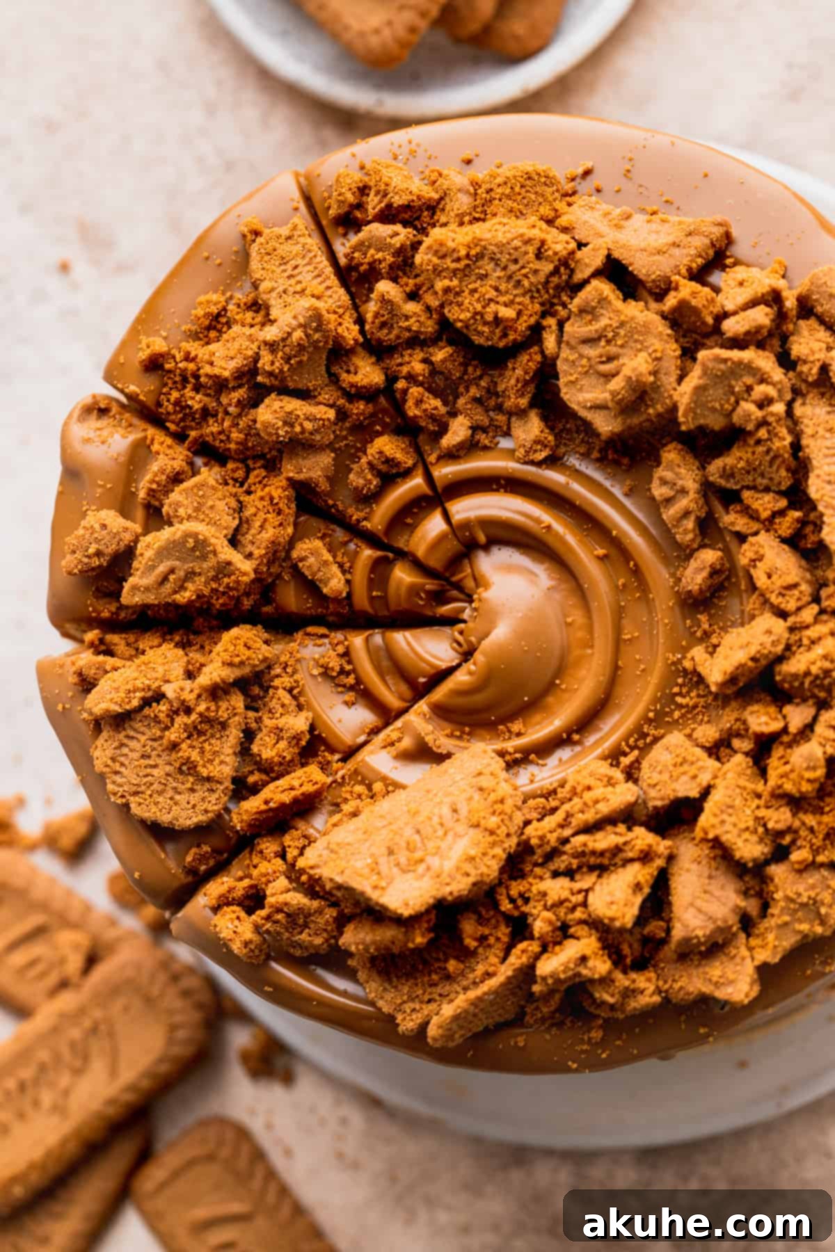 A close-up, top-down view of the Biscoff cake, showcasing its smooth frosting and inviting texture.