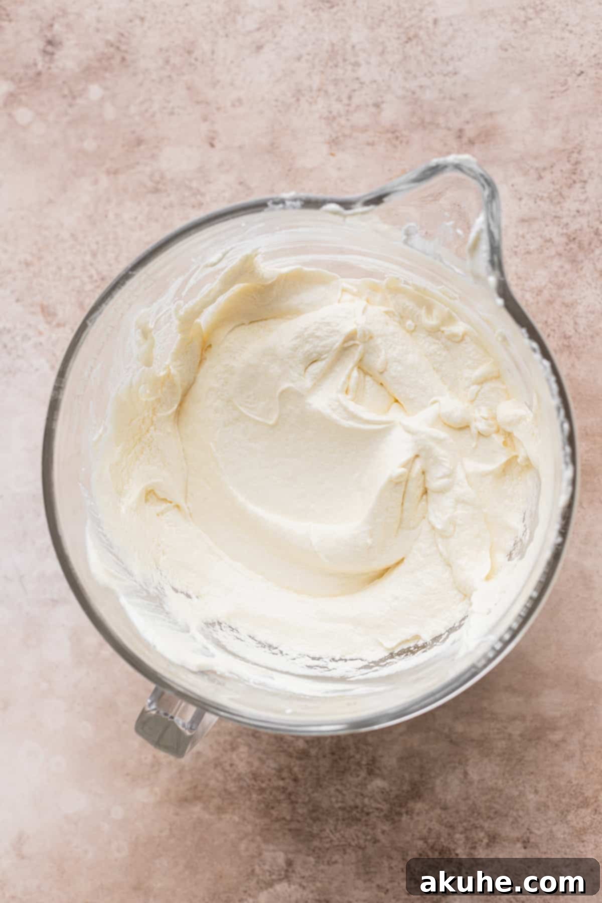 Wet ingredients including eggs, vanilla, and sour cream, blended into the creamed butter and sugar.