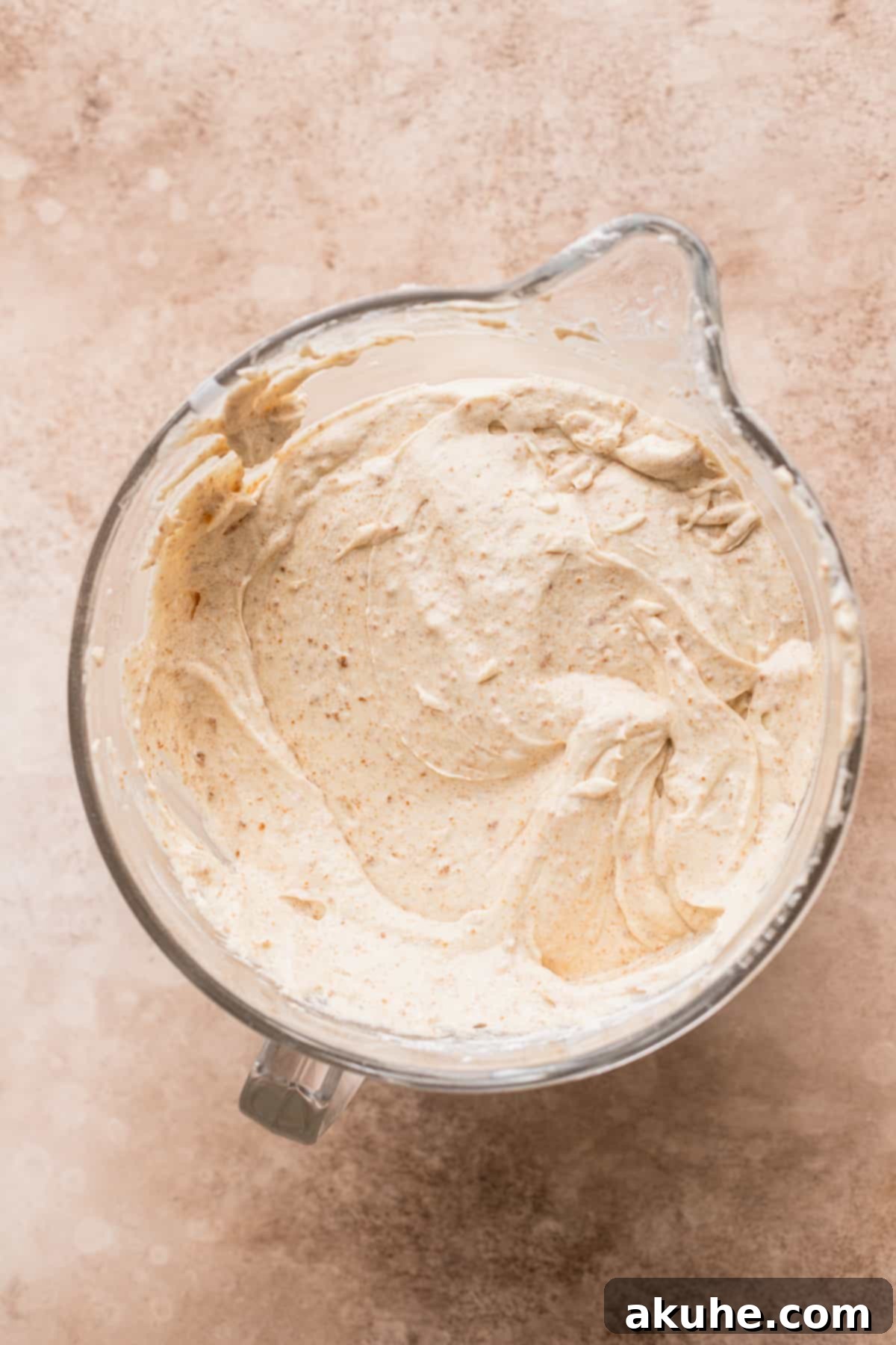 Smooth, light cake batter in a clear glass mixing bowl, ready for baking.