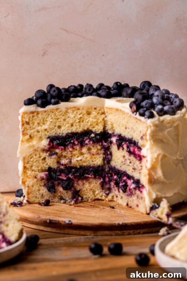 Blueberry Bliss Cake 3 A stunning side view of the expertly sliced blueberry jam cake, showing off its three distinct layers and generous filling.
