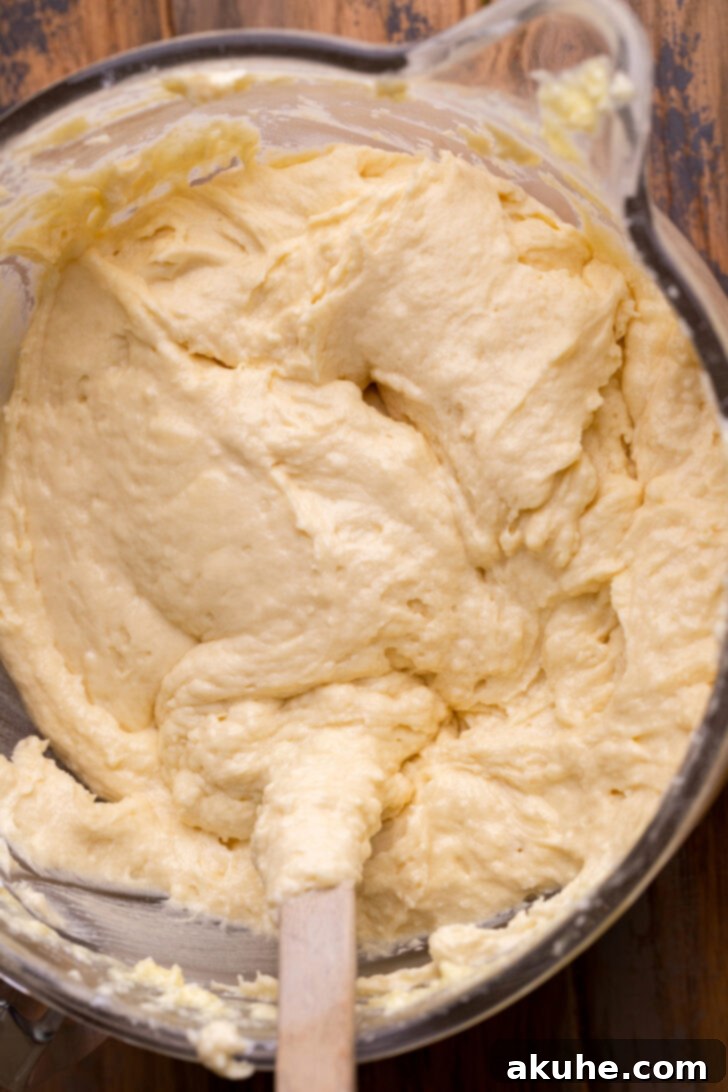 Blueberry Bliss Cake 5 Smooth, spreadable cake batter in a mixing bowl, ready to be divided and poured into cake pans.