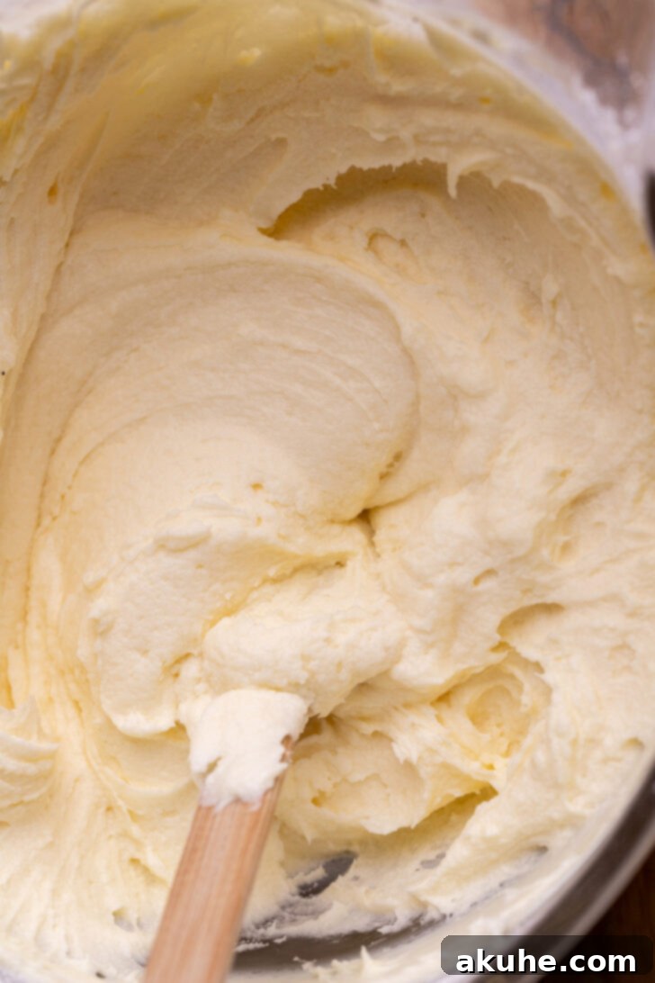 Blueberry Bliss Cake 7 Cream cheese frosting in a bowl, with a note explaining that separation is often due to temperature differences of ingredients.